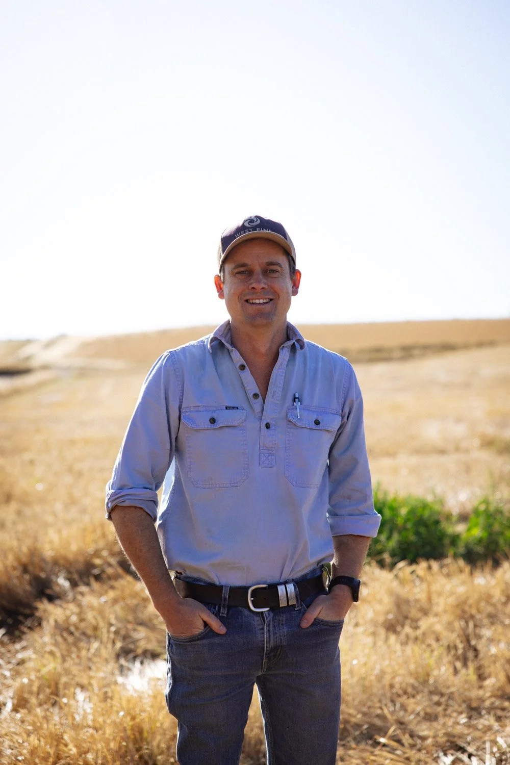 Robert standing outdoors in a paddock, smiling at the camera.