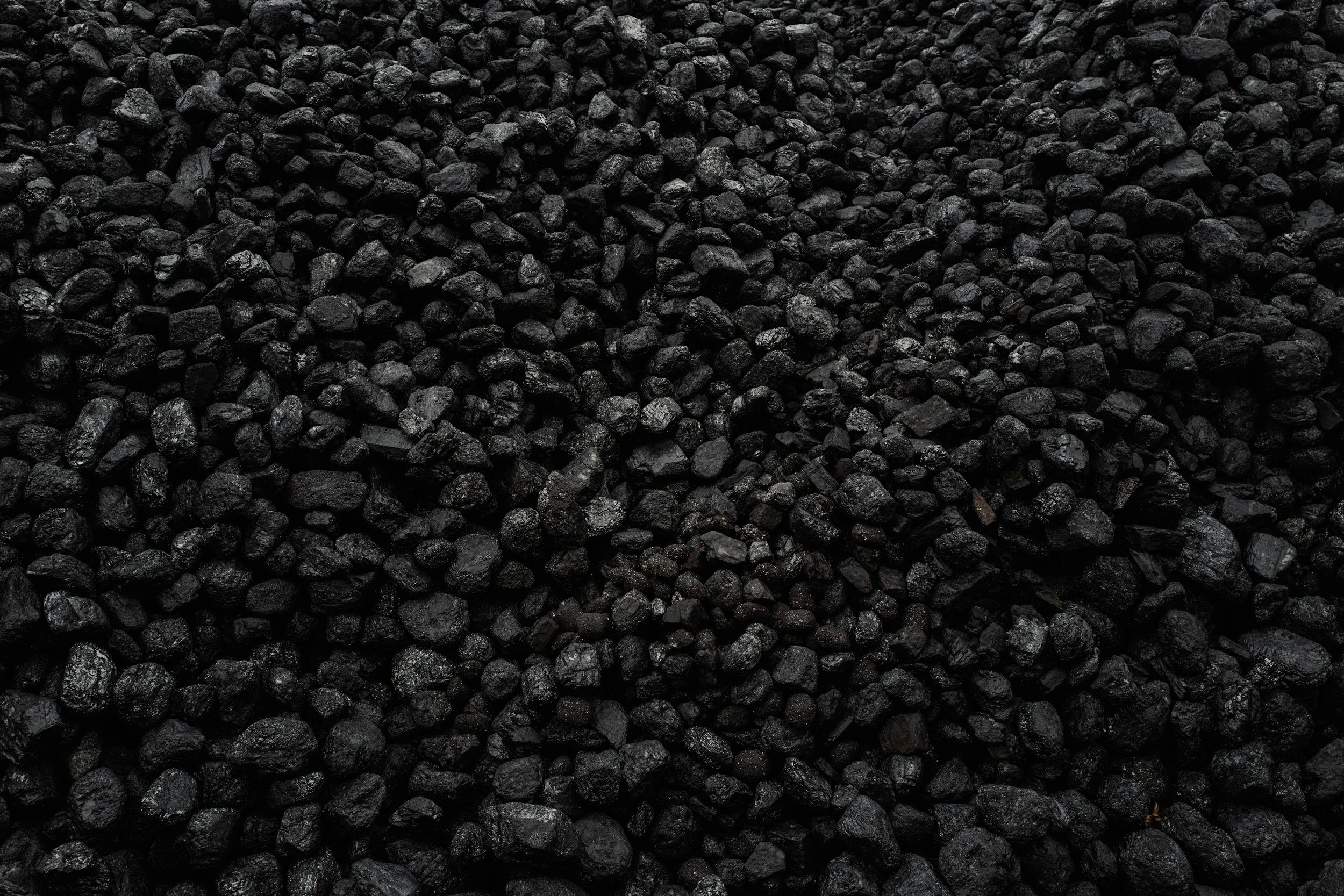 Close-up of small, black, irregularly shaped gravel stones.