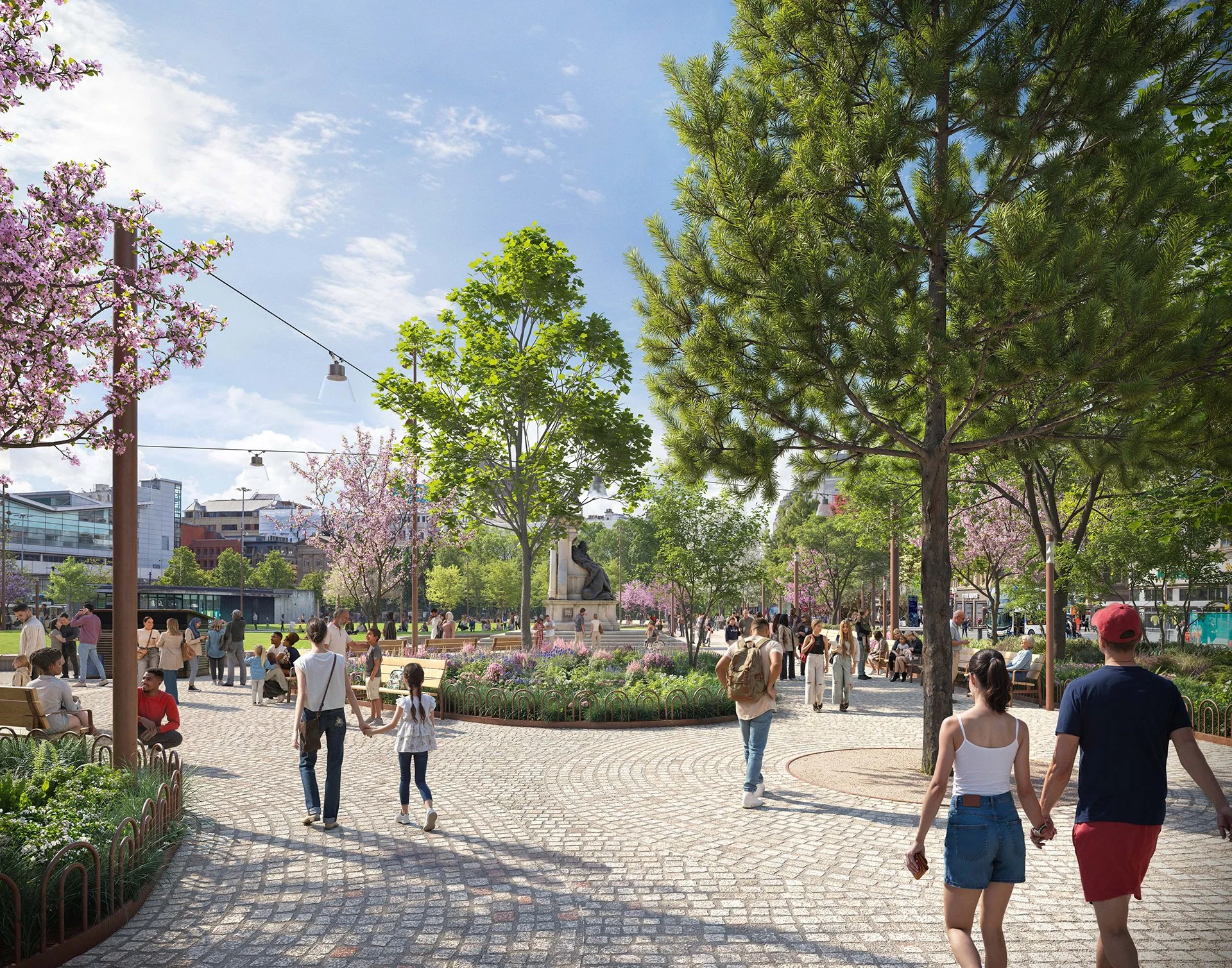 A lively urban park with people walking, sitting, and talking amongst flowering trees and green foliage on a bright day. Buildings are visible in the background.