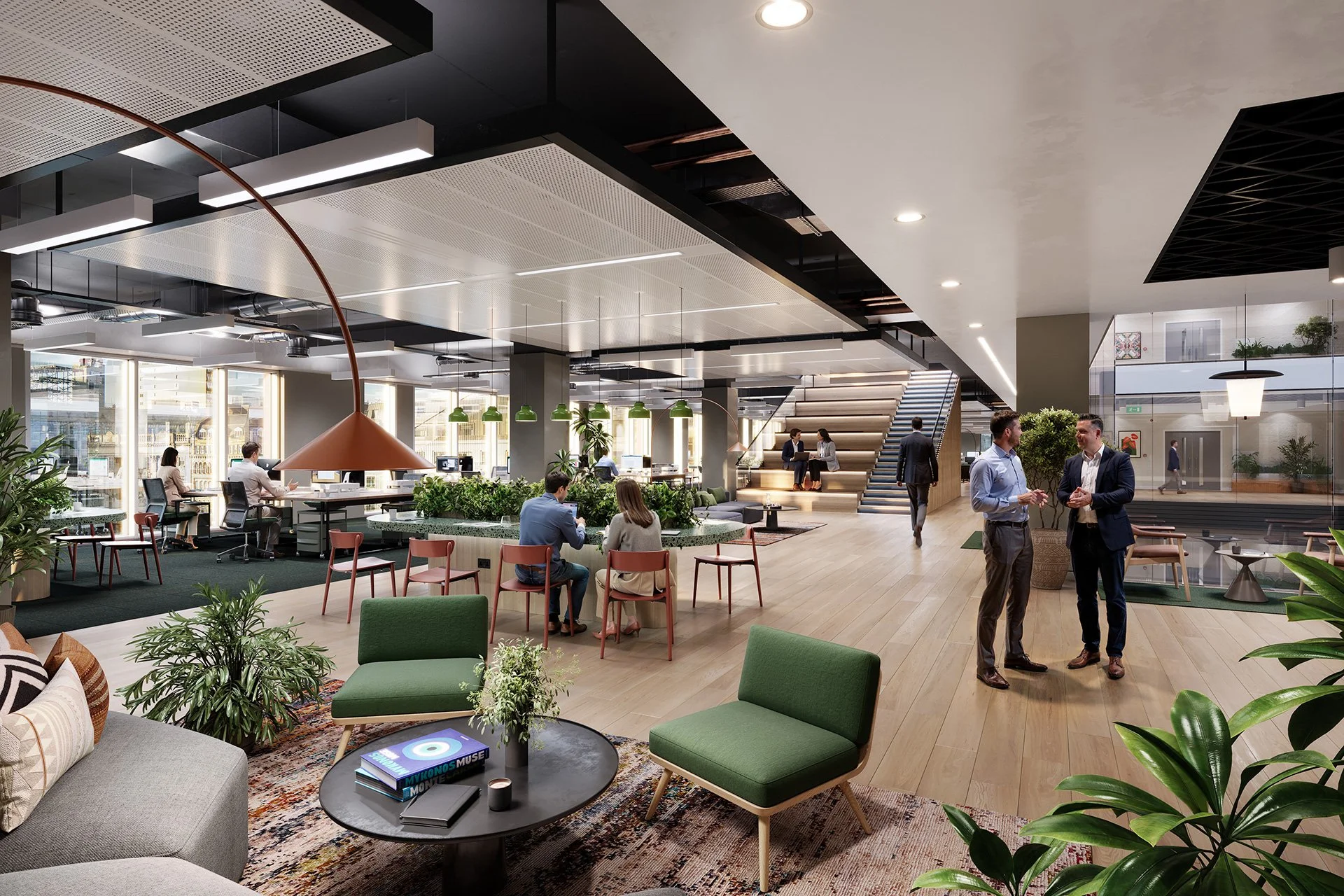 Modern, open-concept office lounge with seating areas, potted plants, and people working and socializing. Bright natural light from large windows, stairs leading to upper level, and contemporary decor with green dining chairs and a mix of couches and