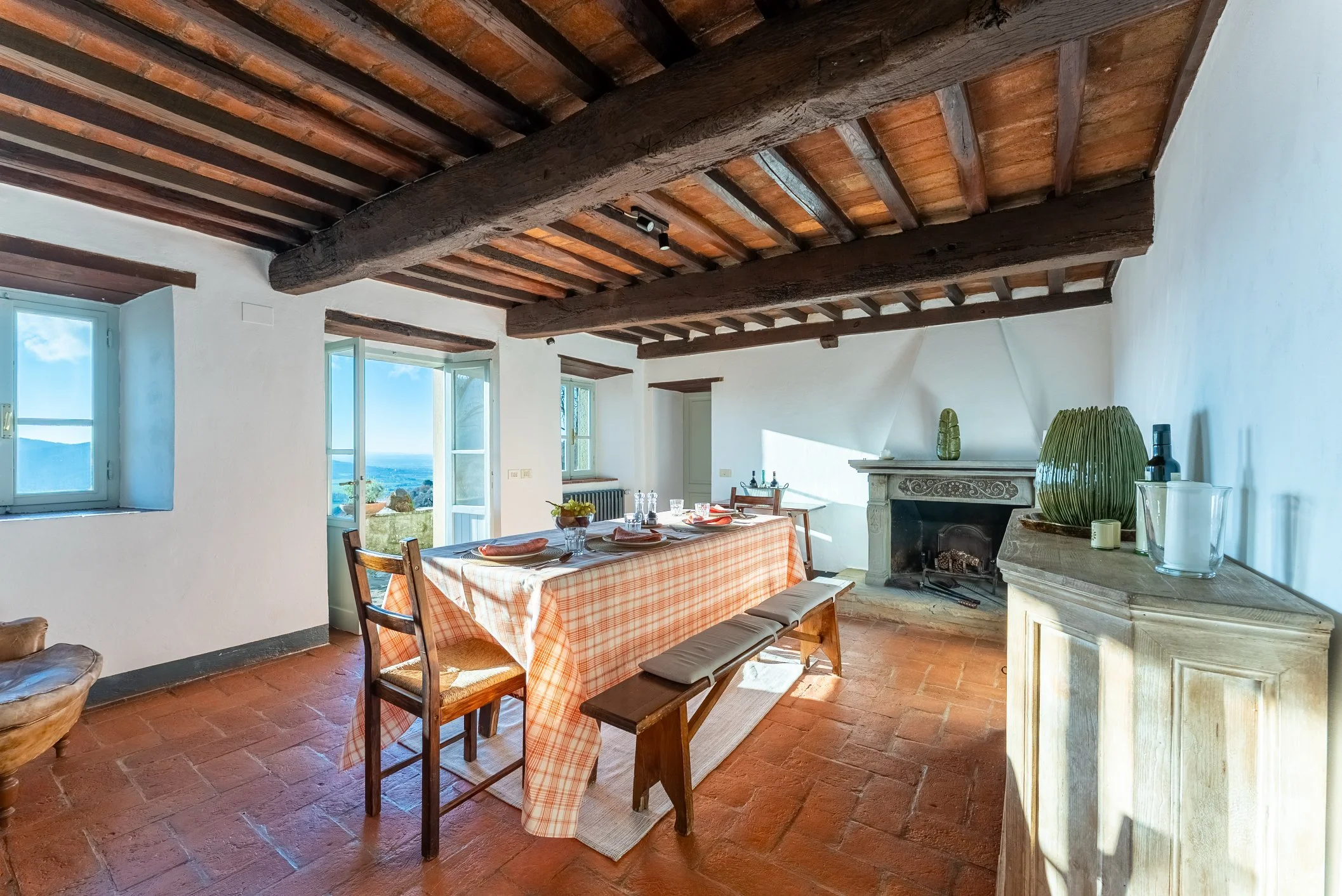 Dining room with original terracotta floors and ceilings at La Casa Cappellina, Tuscany.