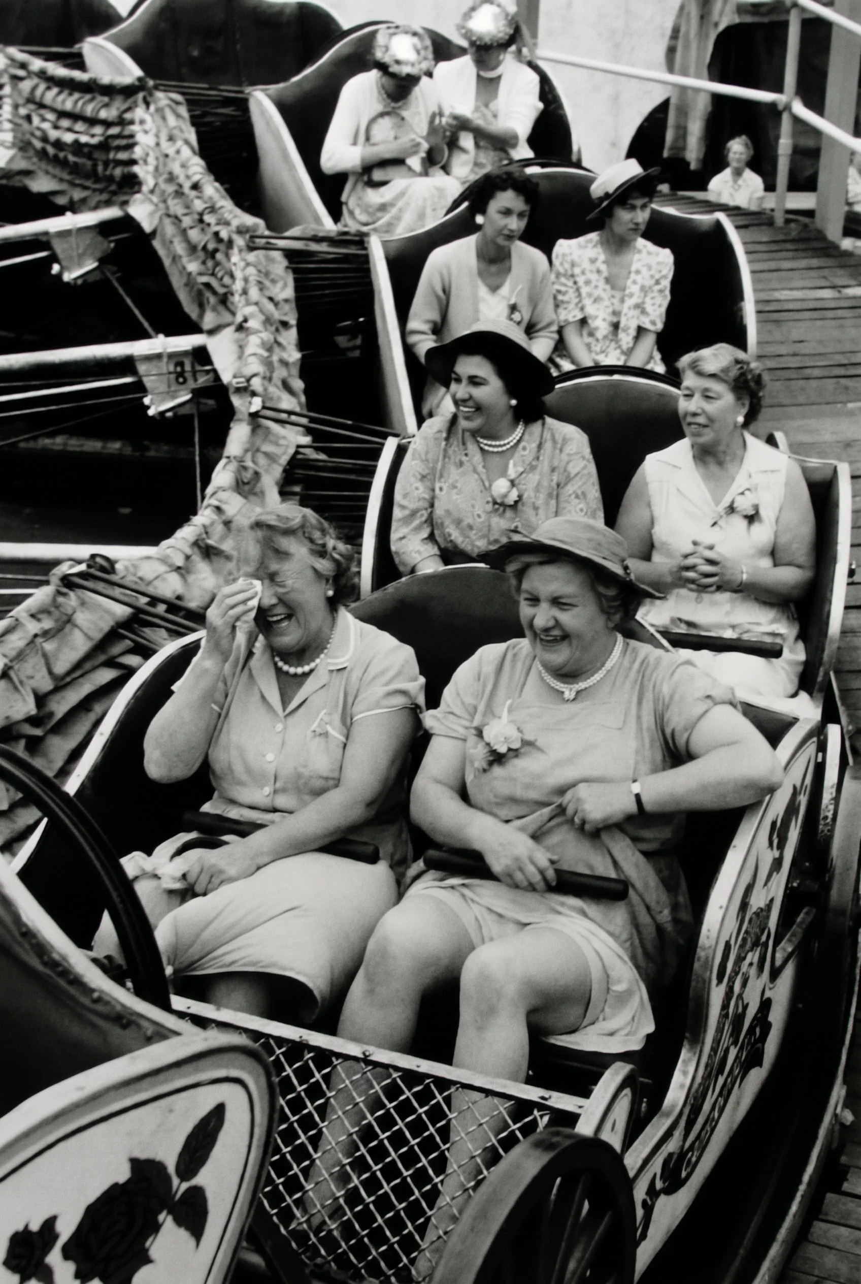 Women enjoying a Daffy roller coaster ride in a vintage-inspired black-and-white photograph.