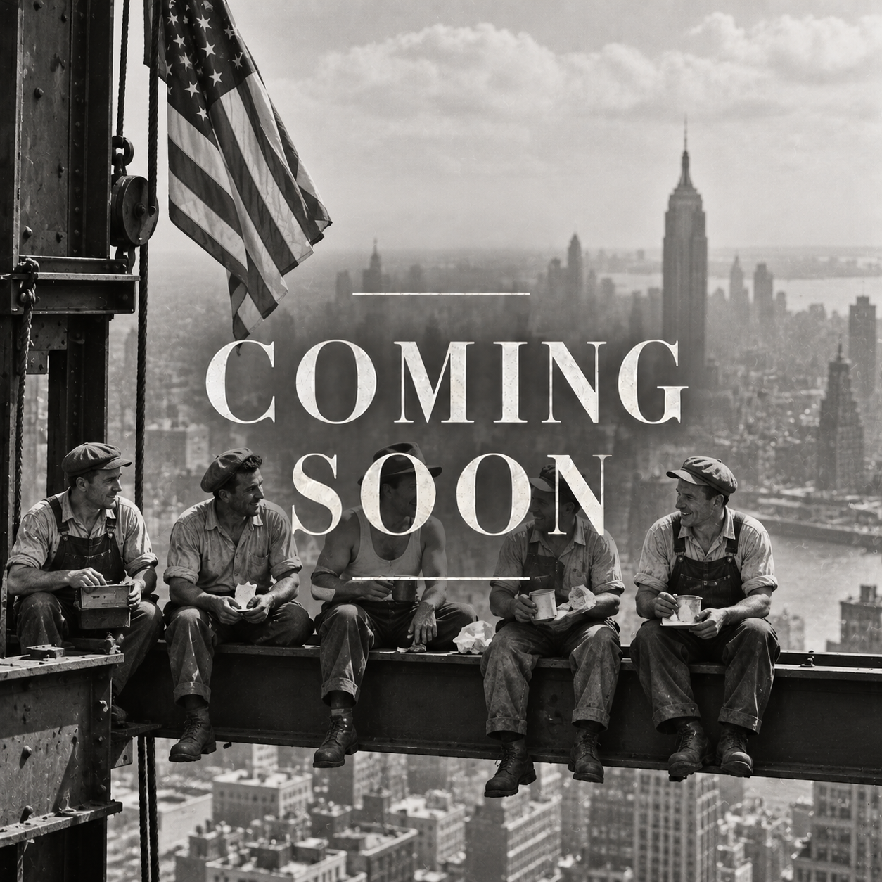 Black and white photo of five workers sitting on a steel beam high above New York City, with the Empire State Building in the background, holding cups and talking to each other, with an American flag on the left side. Overlaid text reads 'Coming Soon'.