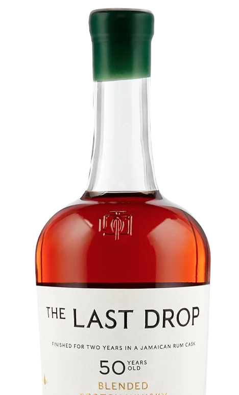 A bottle of rum labeled "The Last Drop," aged 50 years, with a white label and a dark green cap.