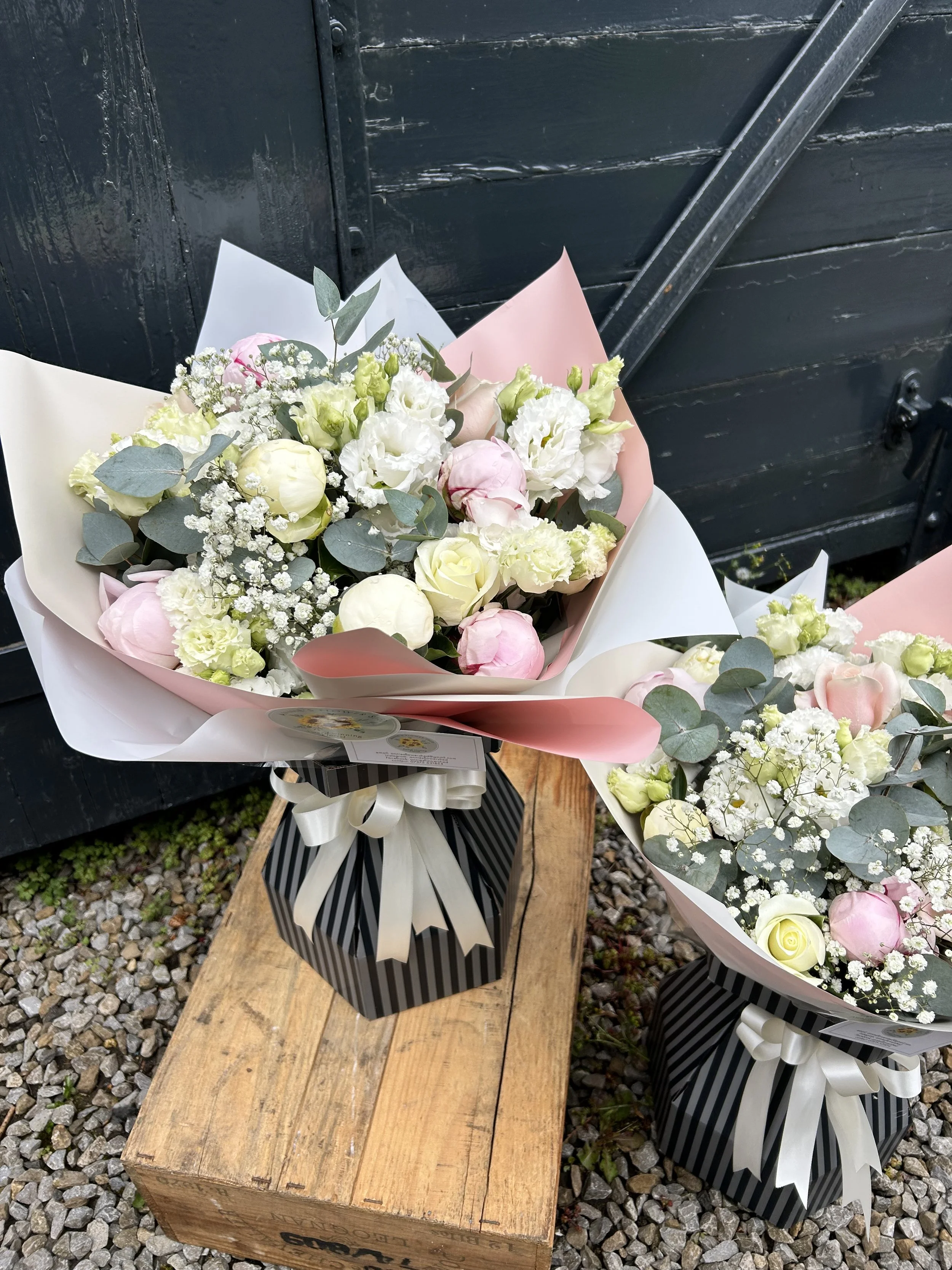 A bouquet of white, pink, and cream flowers.