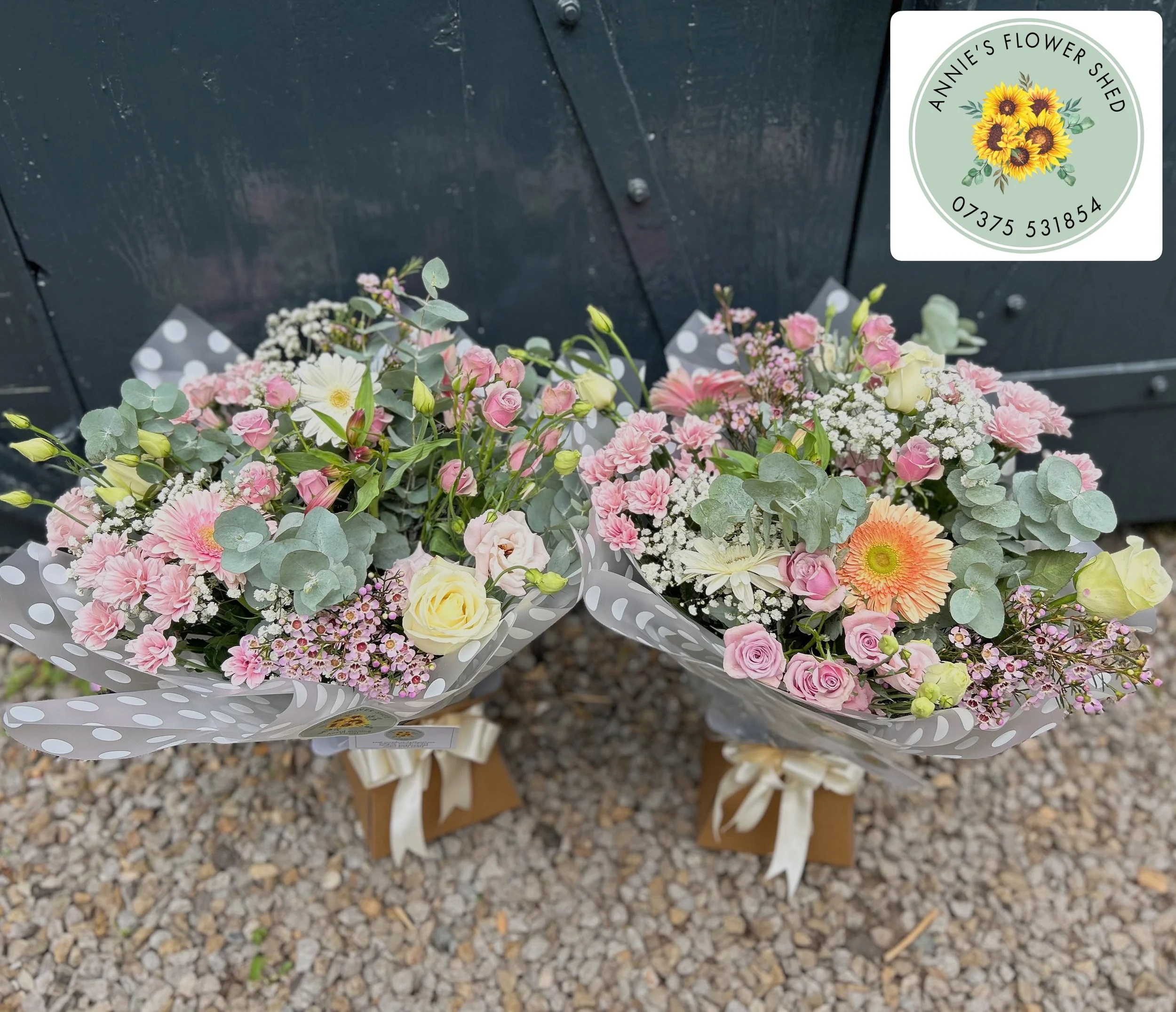 A bouquet of assorted flowers including pink roses, white daisies.
