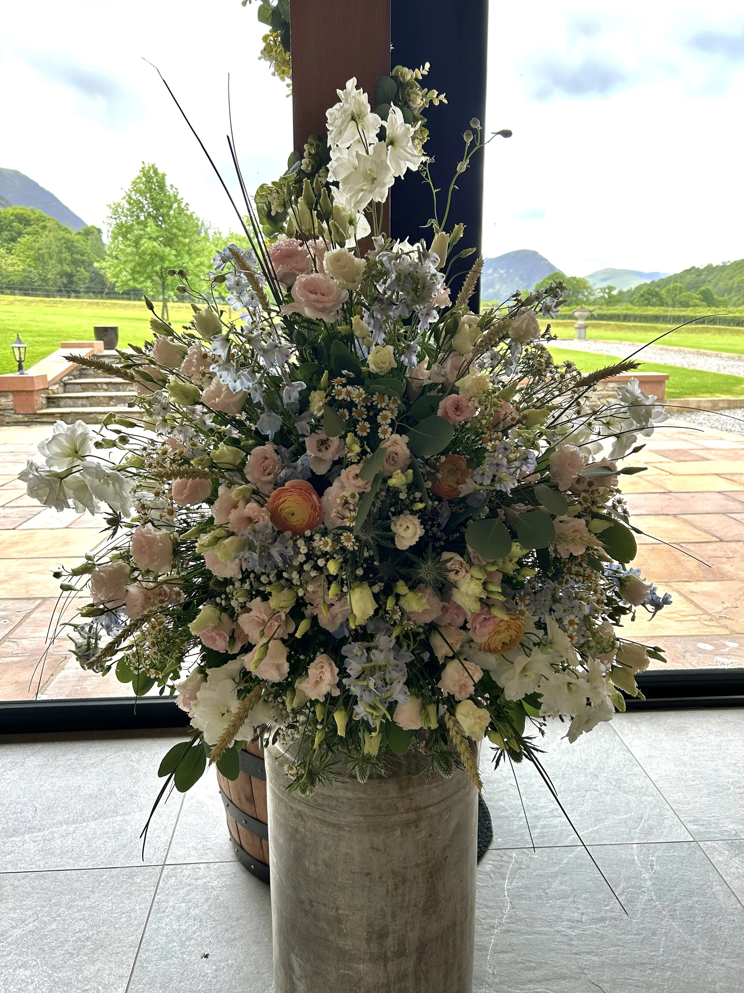 milk churn arrangement made by Annie's Flower Shed.
