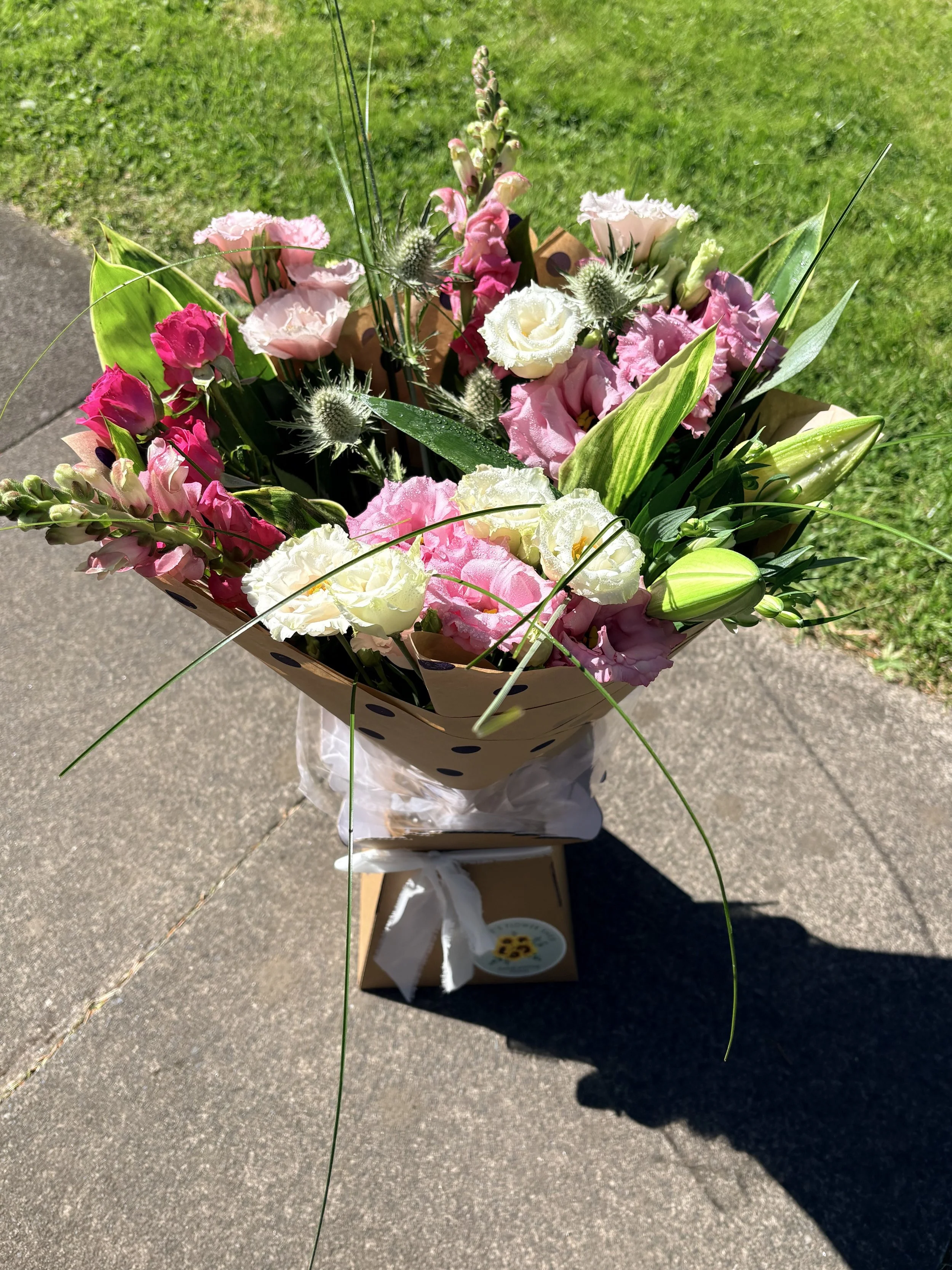 A bouquet of pink, white, and purple flowers 