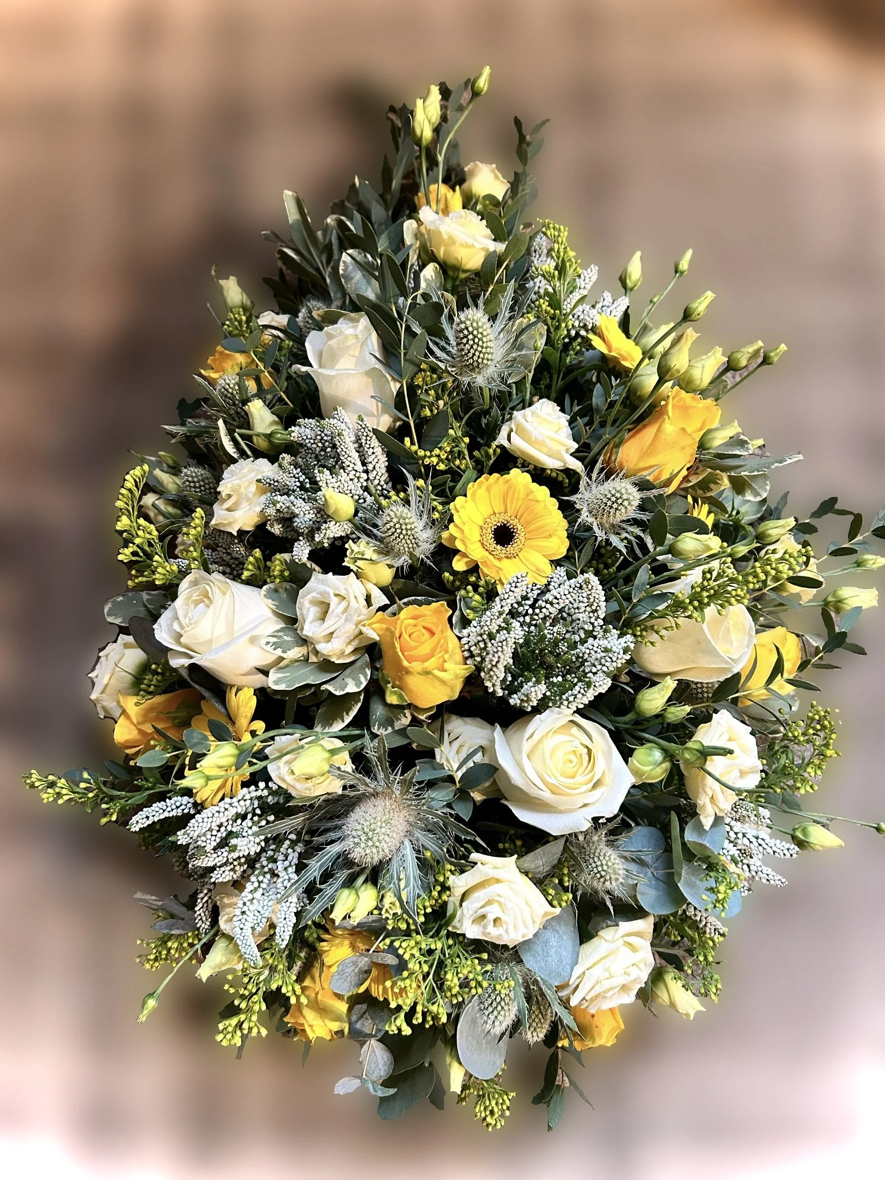 yellow and white funeral arrangement