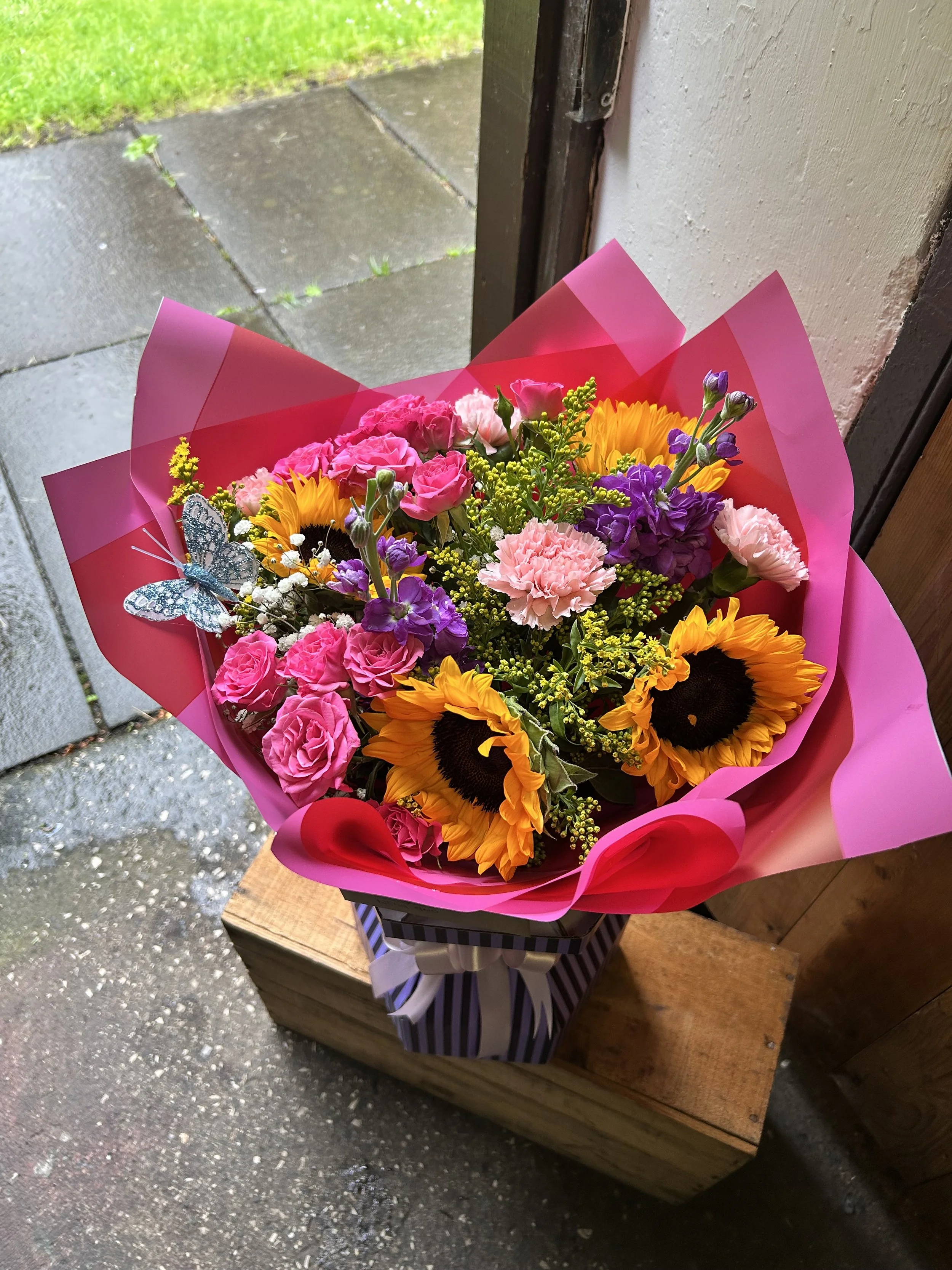 A colorful bouquet of flowers including sunflowers