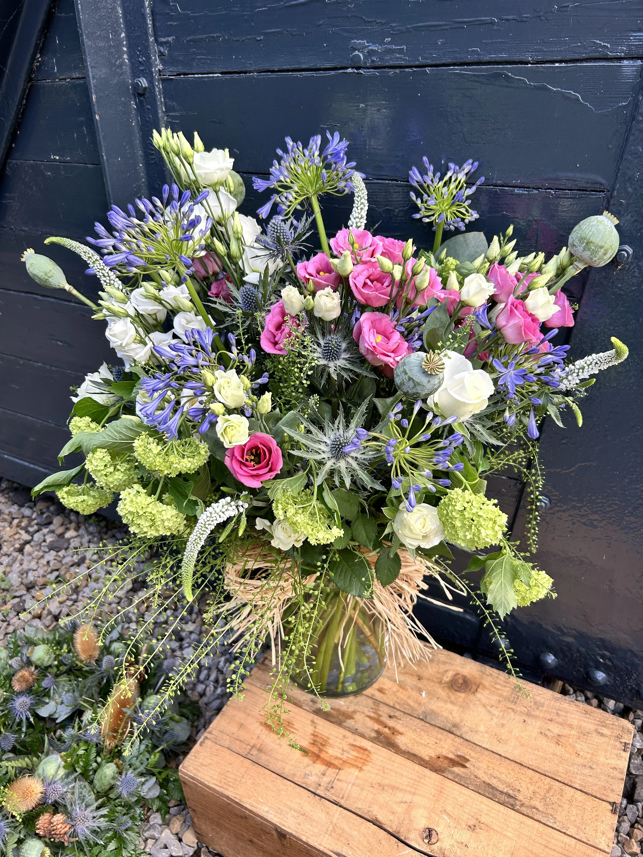 A mixed flower bouquet in a glass vase