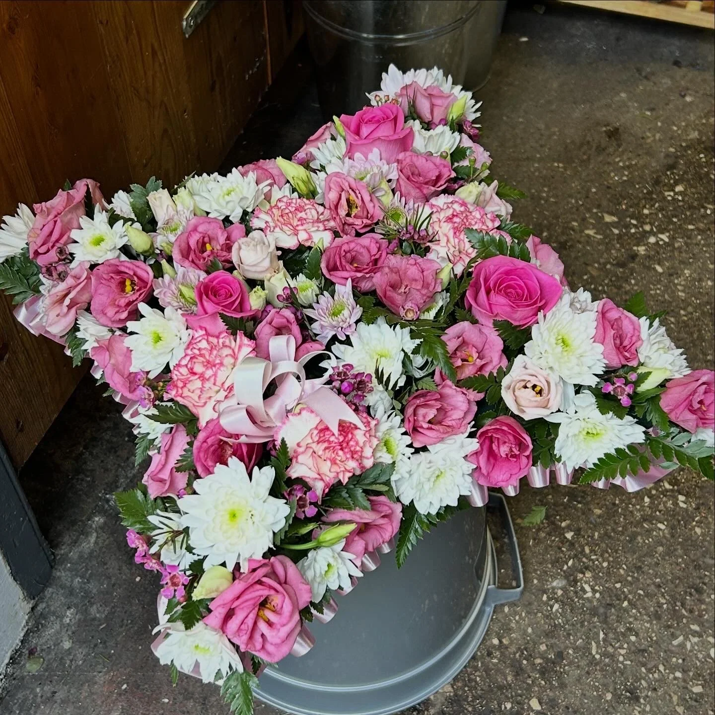 A large floral arrangement with pink roses
