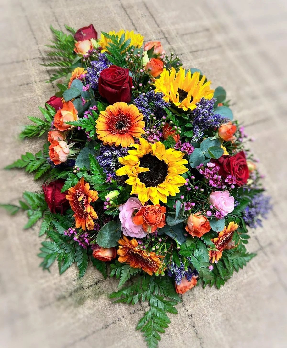 A vibrant flower arrangement featuring sunflowers.