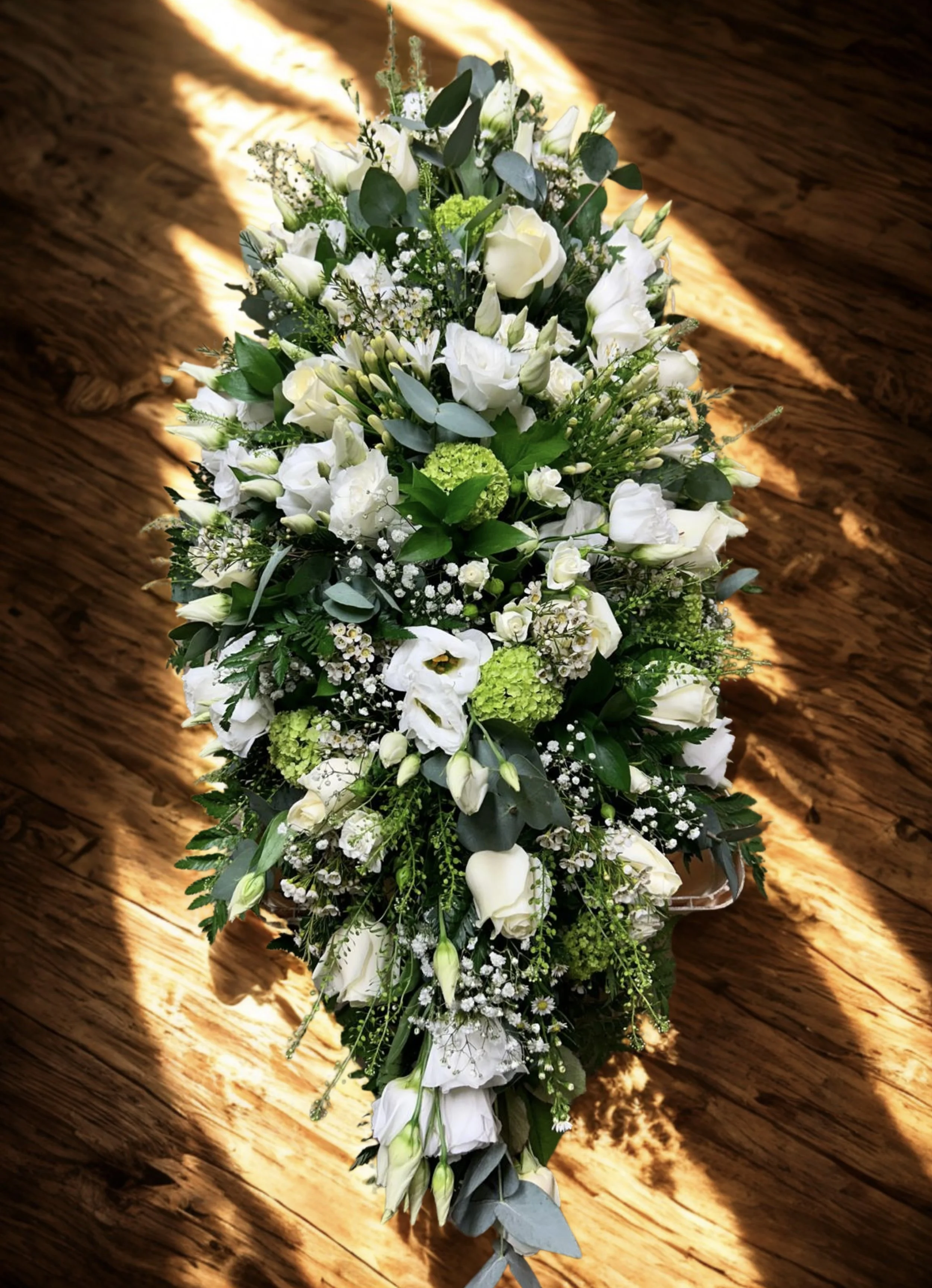 white casket spray made by Annie's Flower Shed.