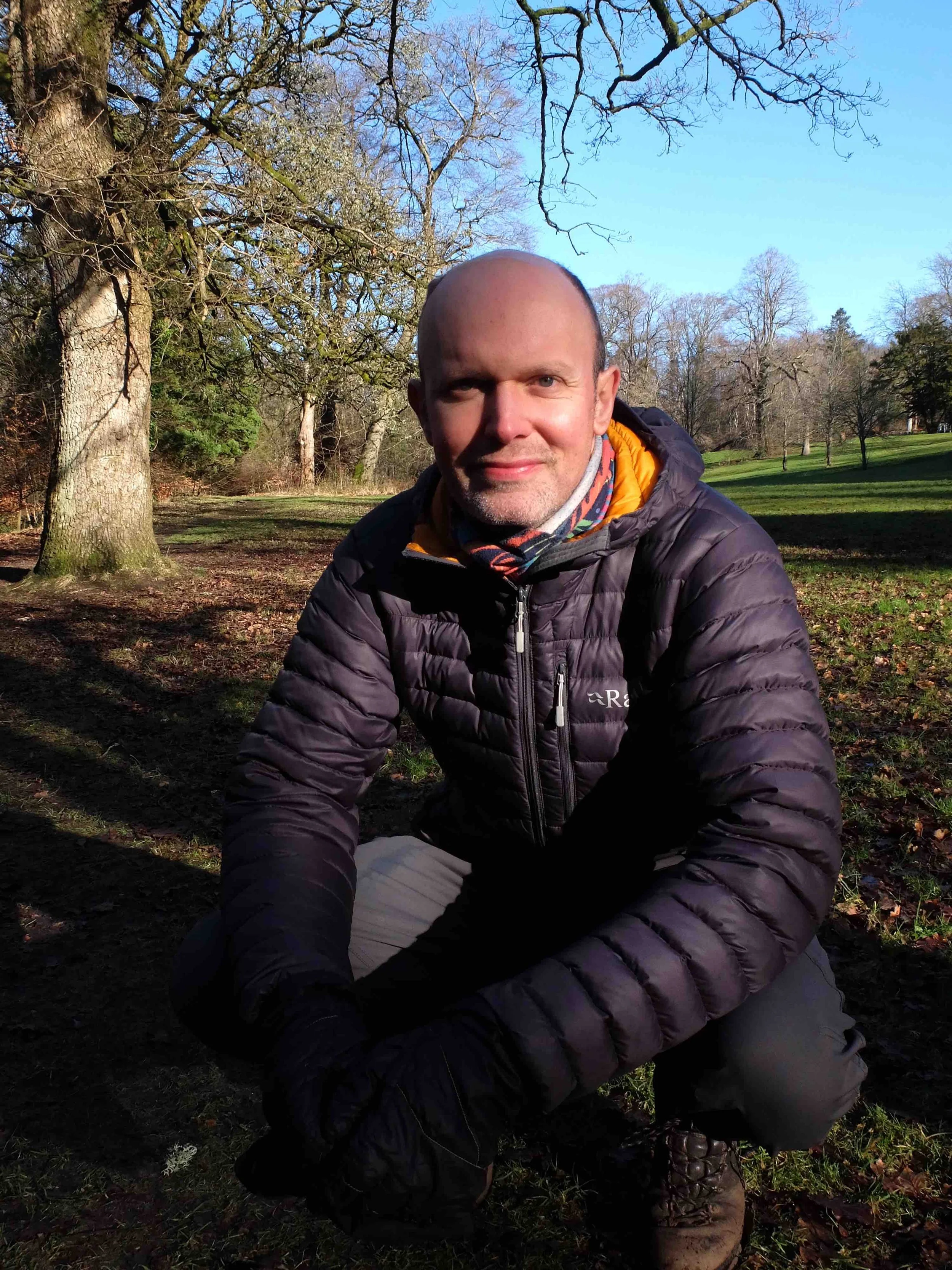 Giuseppe Mistretta Counsellor - crouching near trees - Linn Park, Glasgow