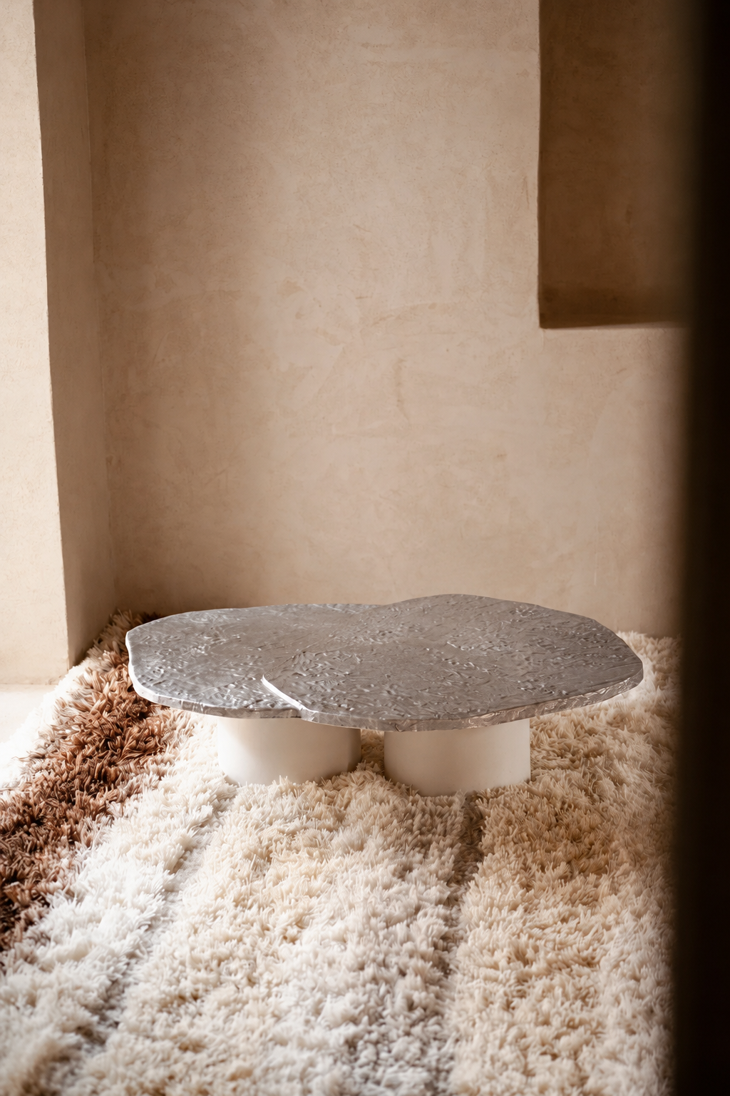 Sculptural Stone Table on Shag Rug.png
