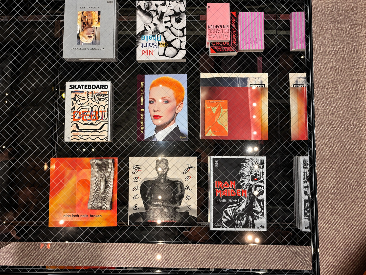 Curated Books Beneath Glass Mesh.png