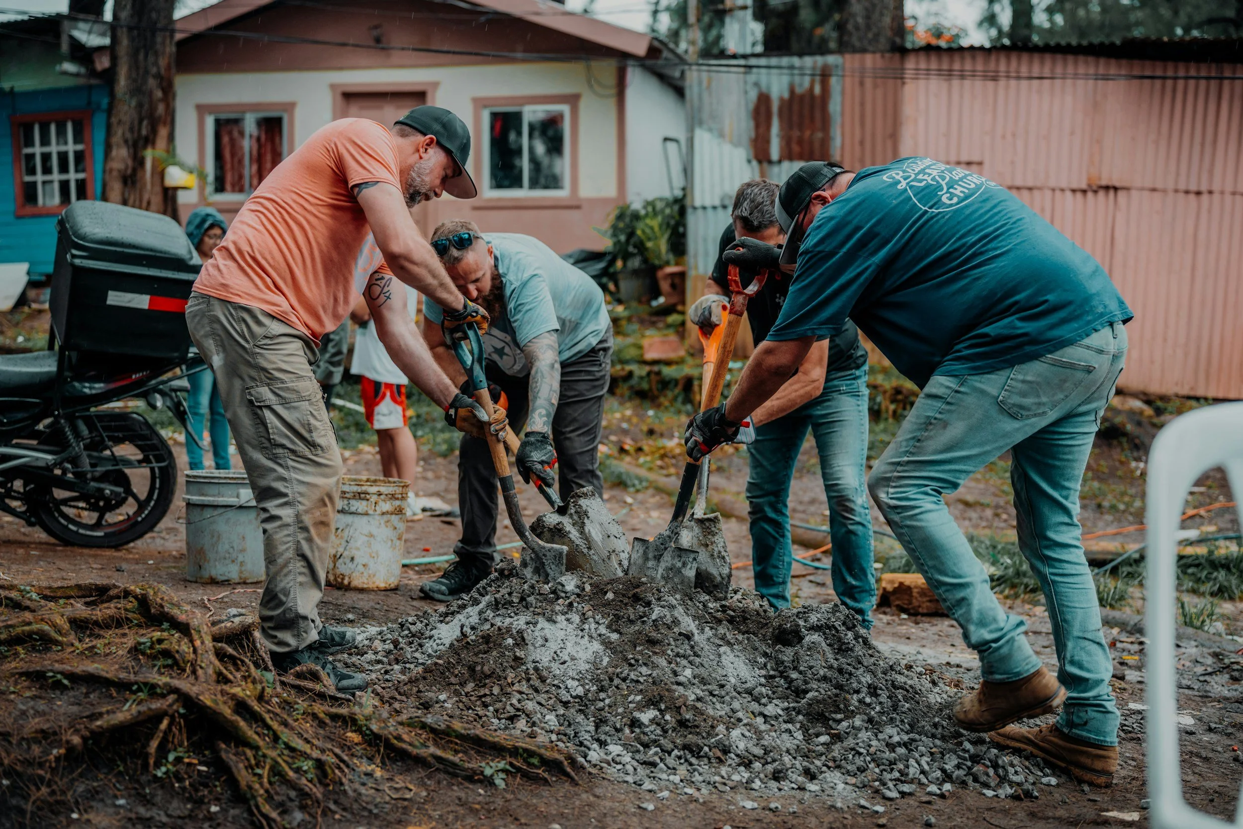 Volunteers working together on a construction site — illustrative stock photograph.
