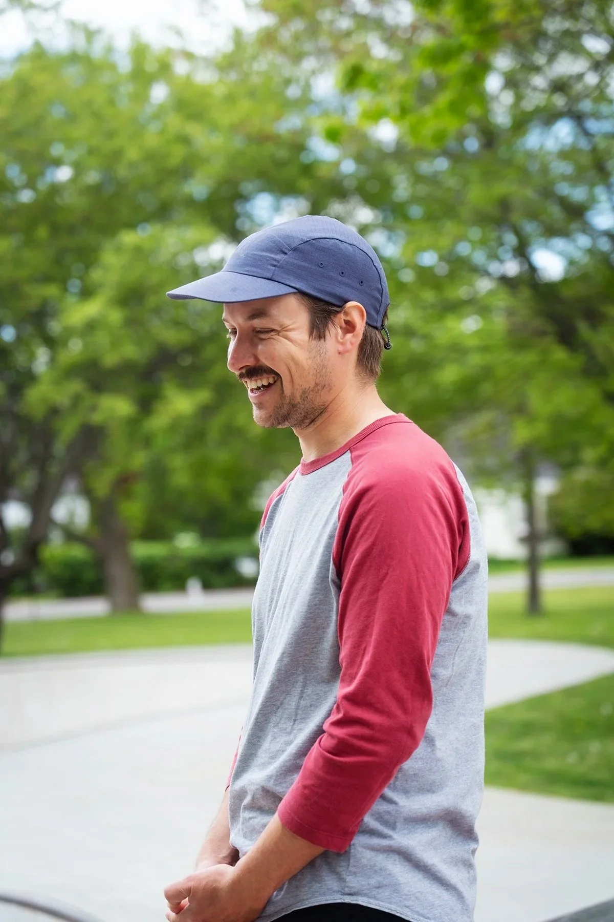 candid headshot of skate instructor jack lally, smiling in a baseball cap.