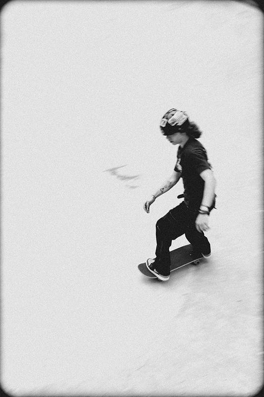 Black and white image of someone skateboarding.