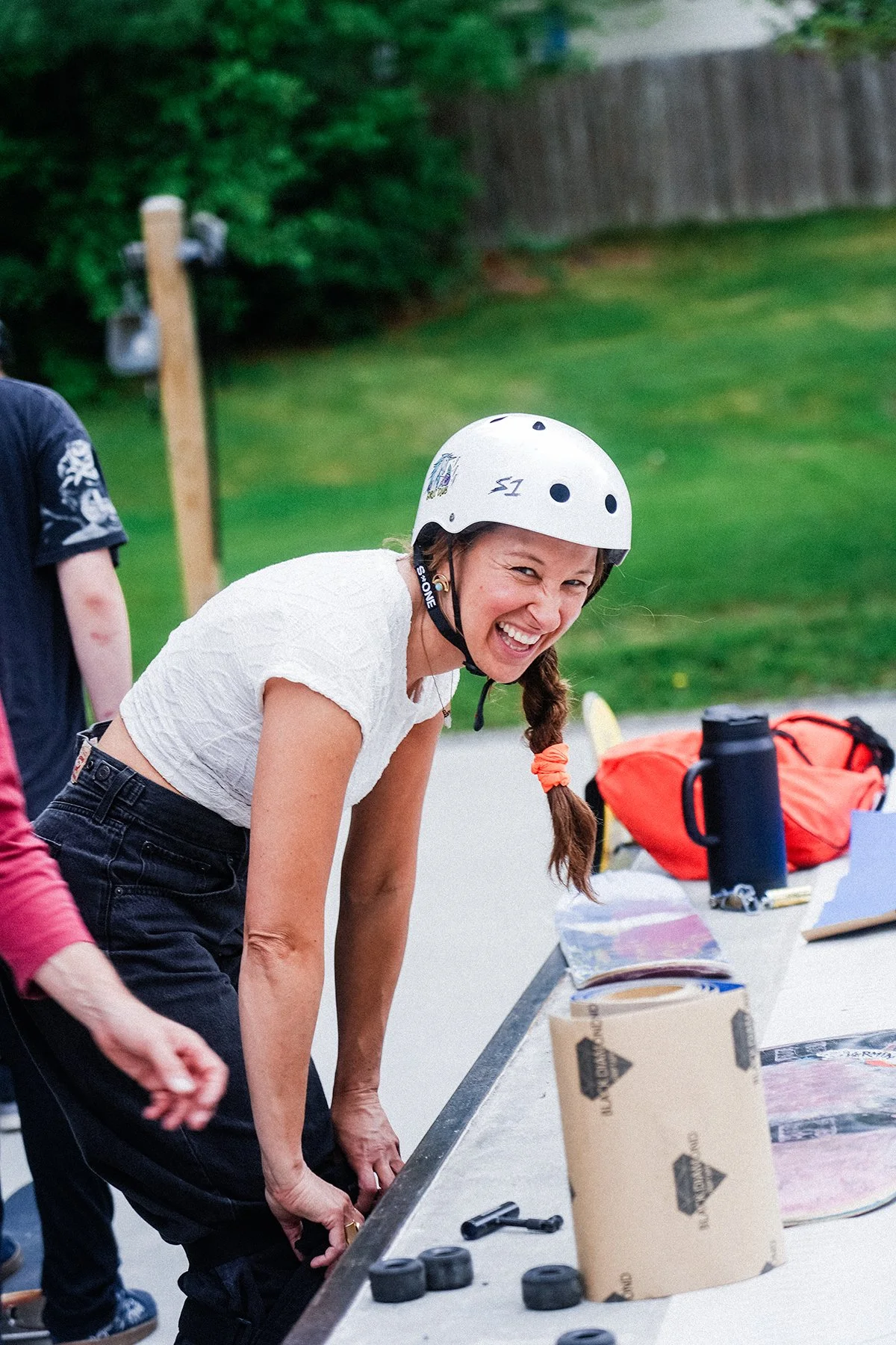 candid laughing image of the skate to relate executive director laughing in a helmet.