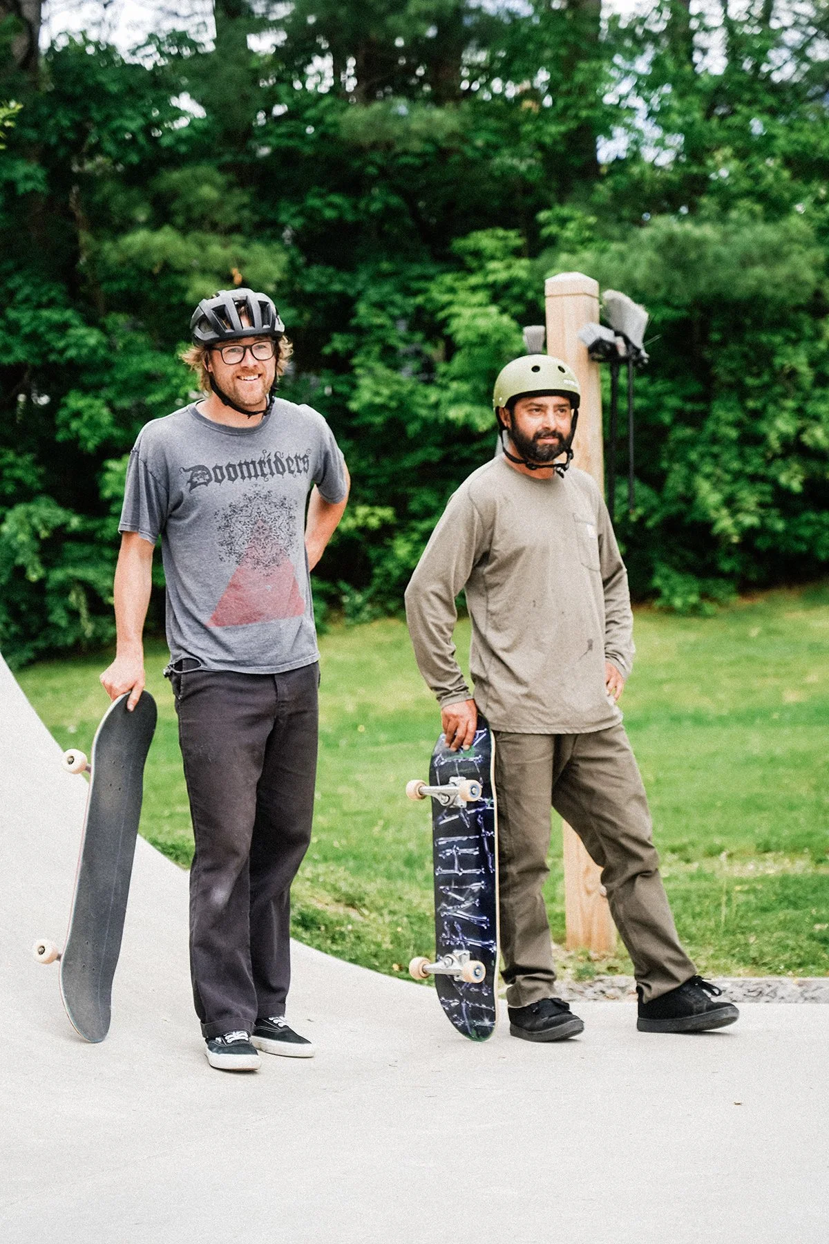 two skate to relate staff candidly watching someone skate, though the skater is out of frame.