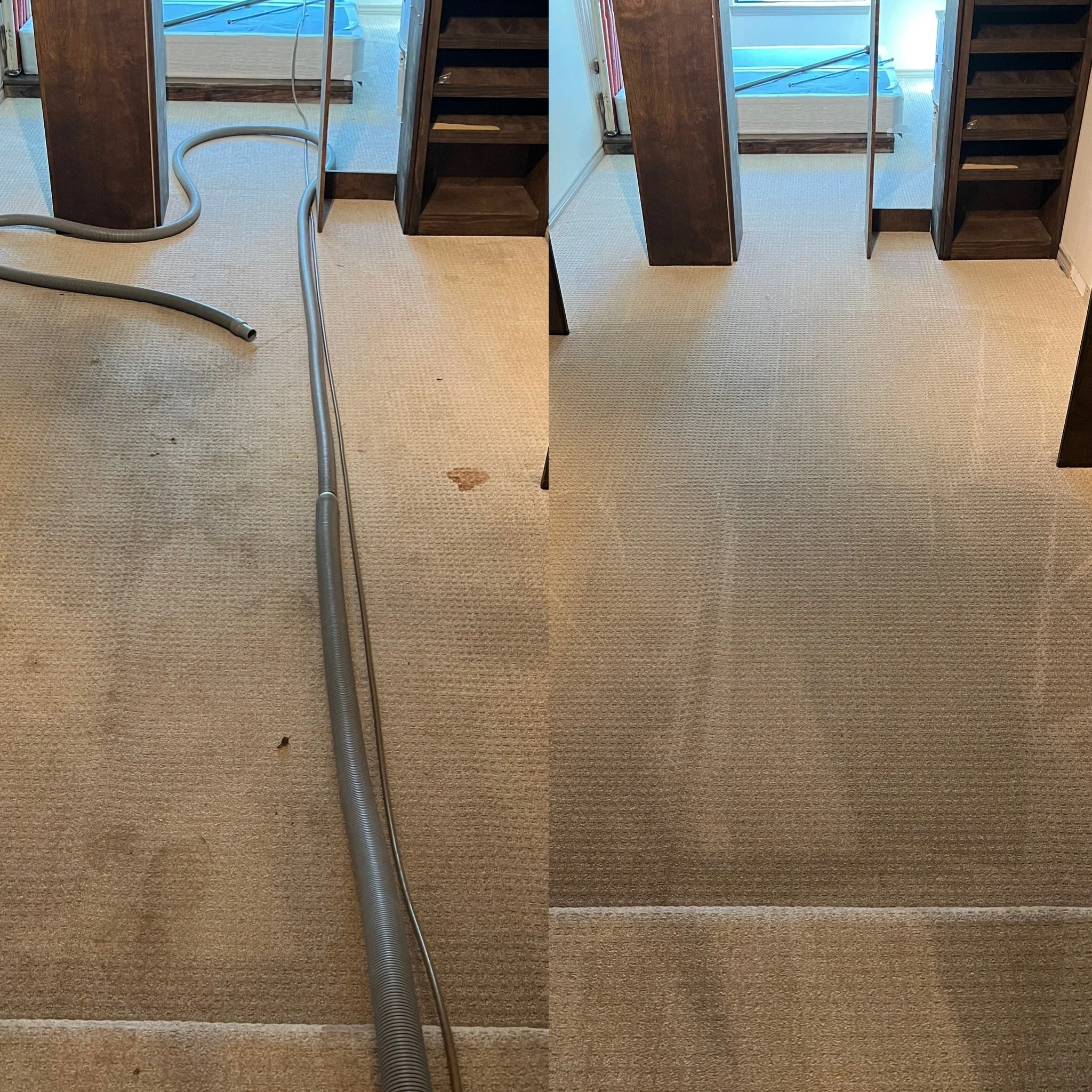 A carpeted room with a wooden staircase, a vacuum hose on the carpet, and a hot tub visible through a sliding glass door in the background.