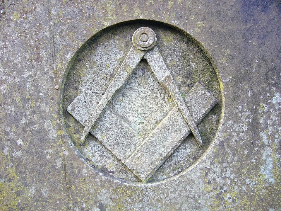 A Square & Compasses, carved in sone.