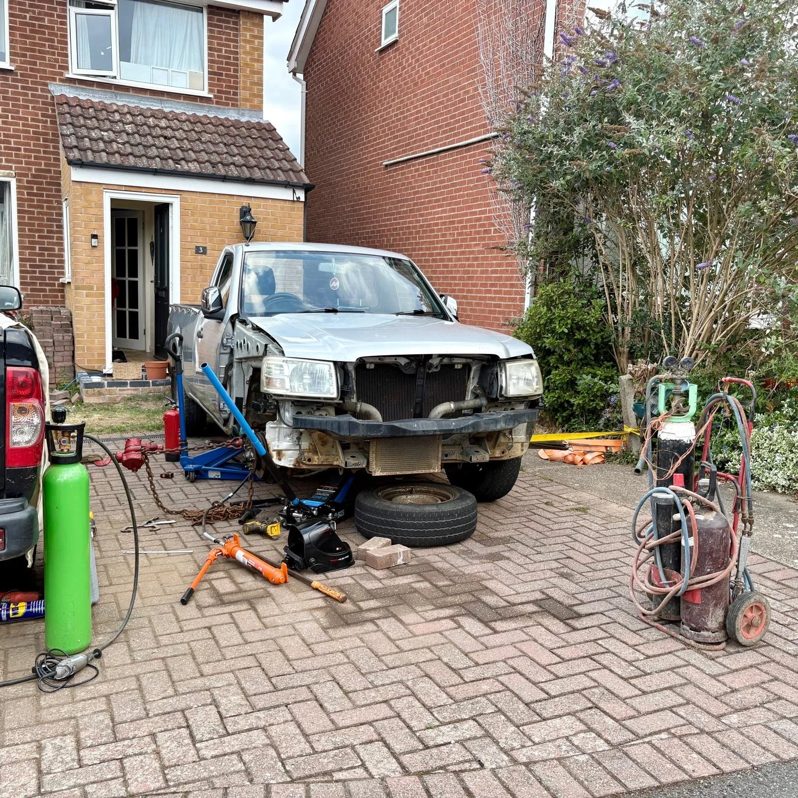 The bumper and wheels removed to access the bent area.