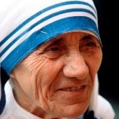 Close-up of an elderly woman wearing a blue and white striped headscarf.