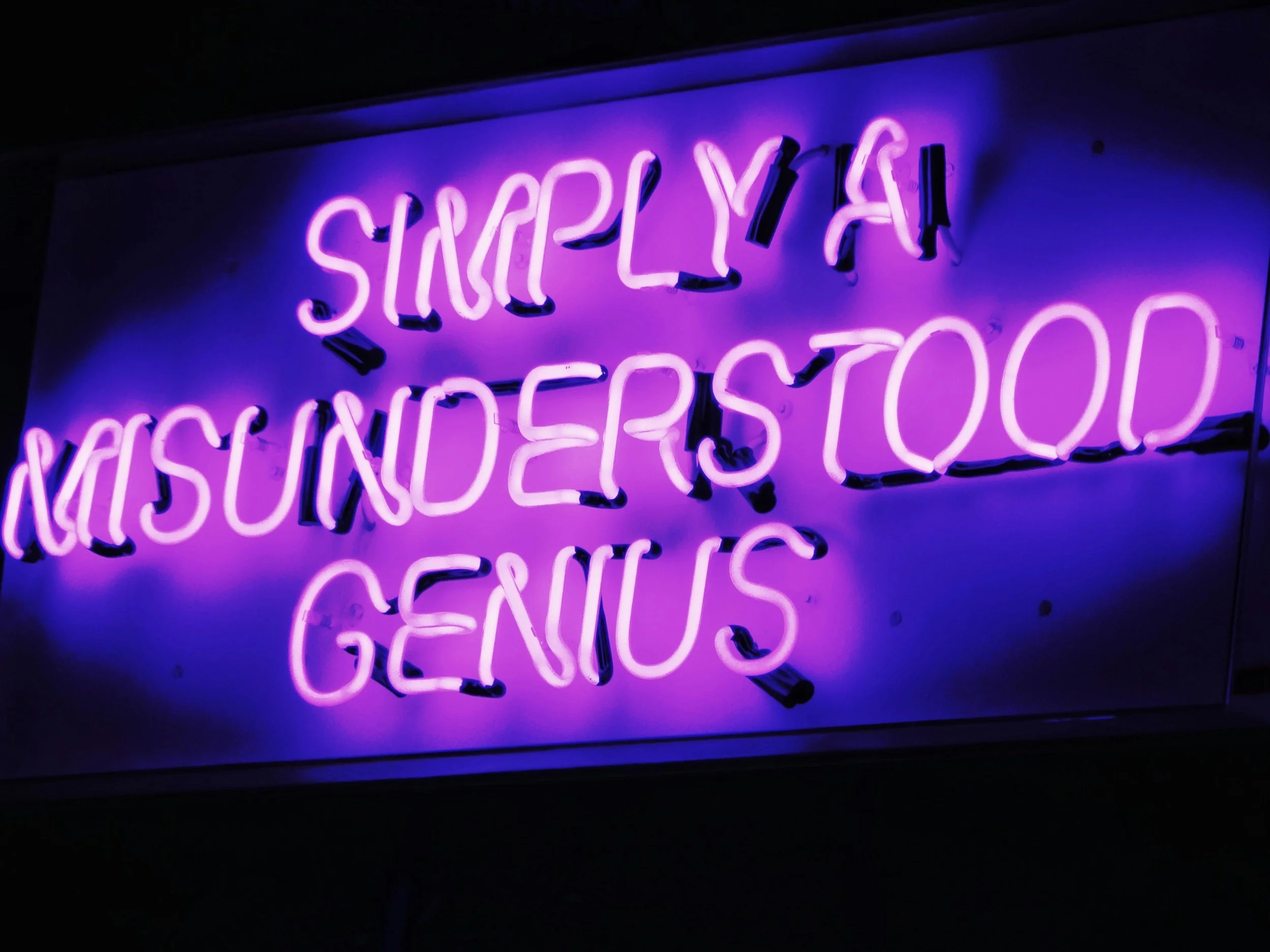 A neon sign with purple light reads 'SNACK Y' and parts of additional words are visible but not fully clear.