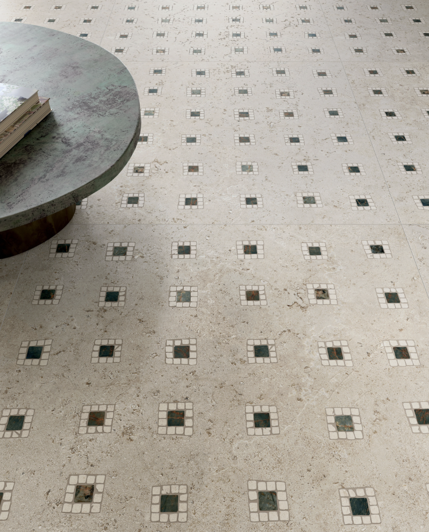Een vloerkleed met een blokpatroon naast een ronde tafel met boeken.