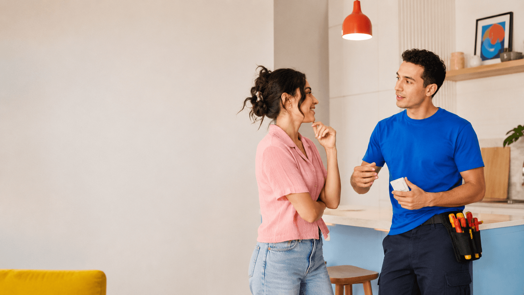Homeowner talking with a residential electrician during an electrical service visit in Central Florida.