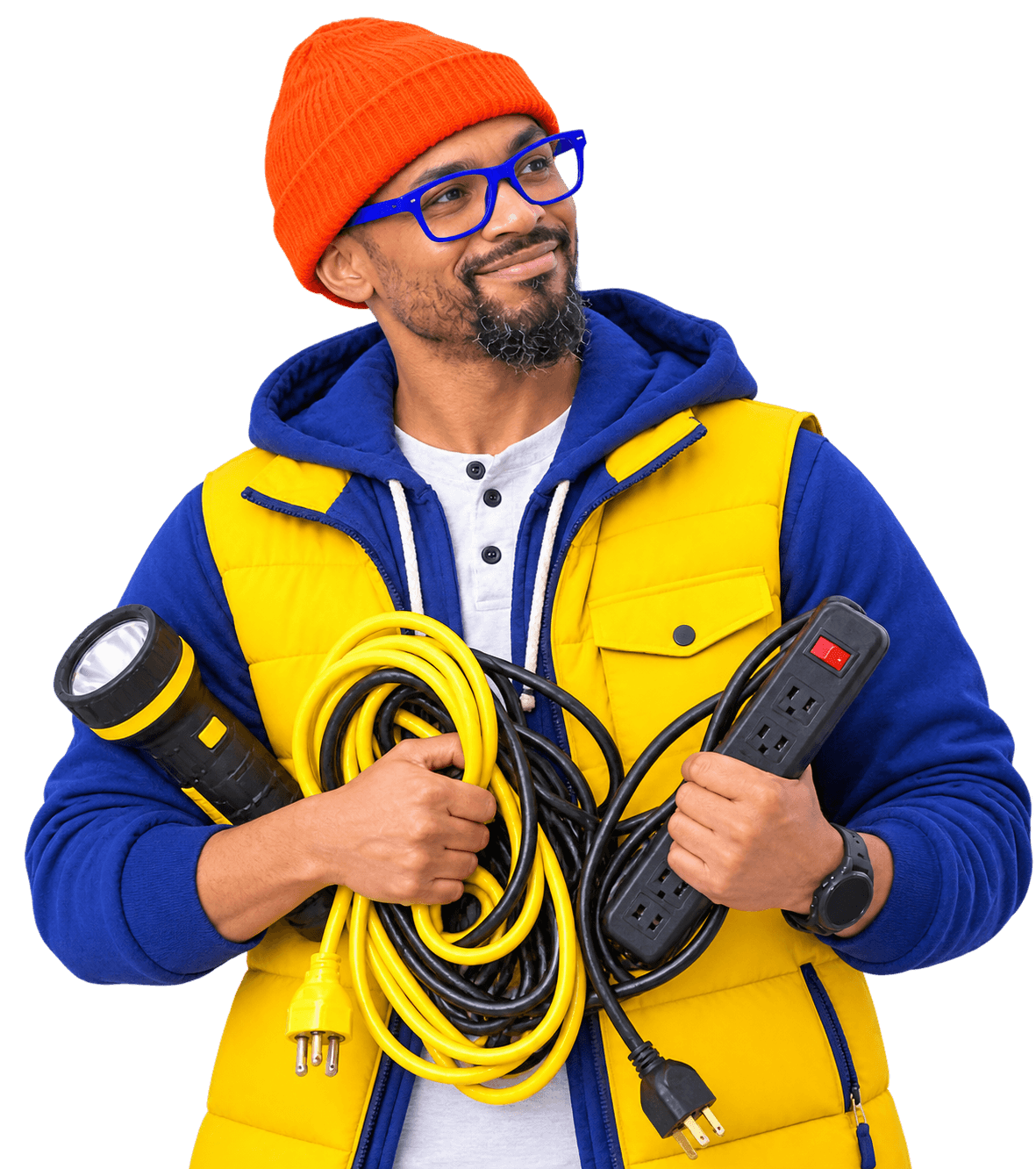 A man wearing a bright orange beanie, blue glasses, blue hoodie, and yellow padded vest holds tangled electrical cords and a flashlight, smiling.