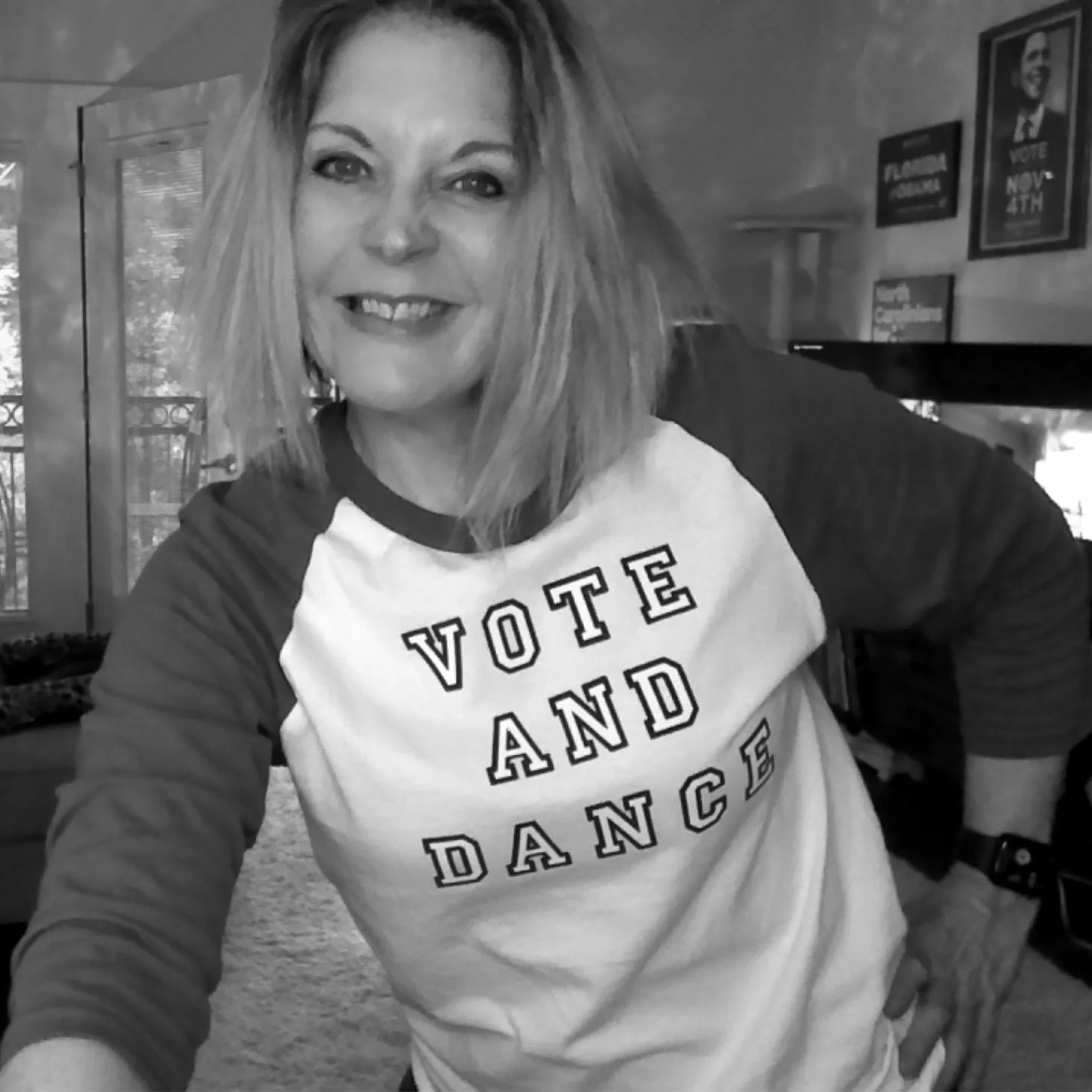 Claudette Silver smiling and wearing a shirt that says "vote and dance."