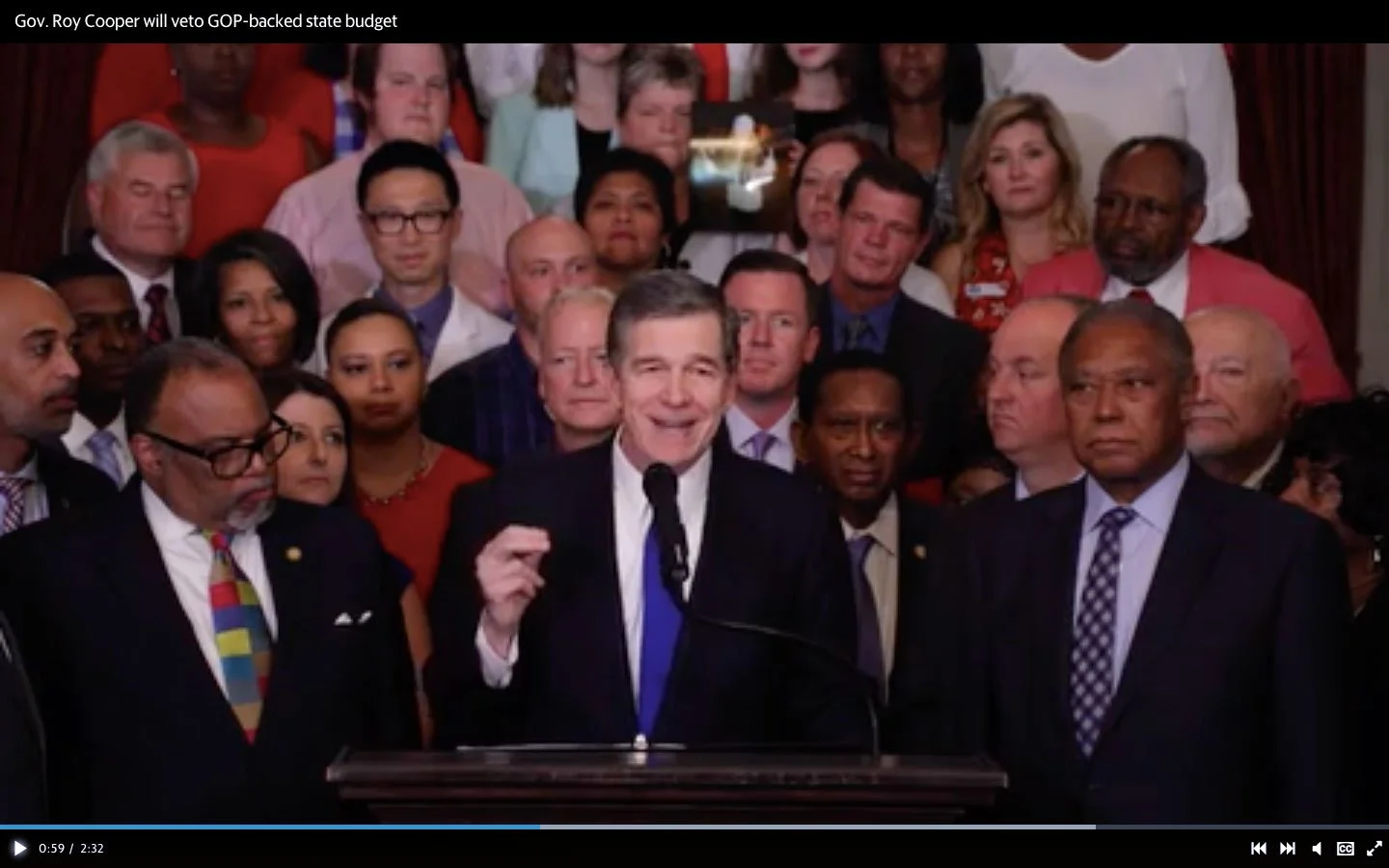 Governor Cooper on television giving a speech