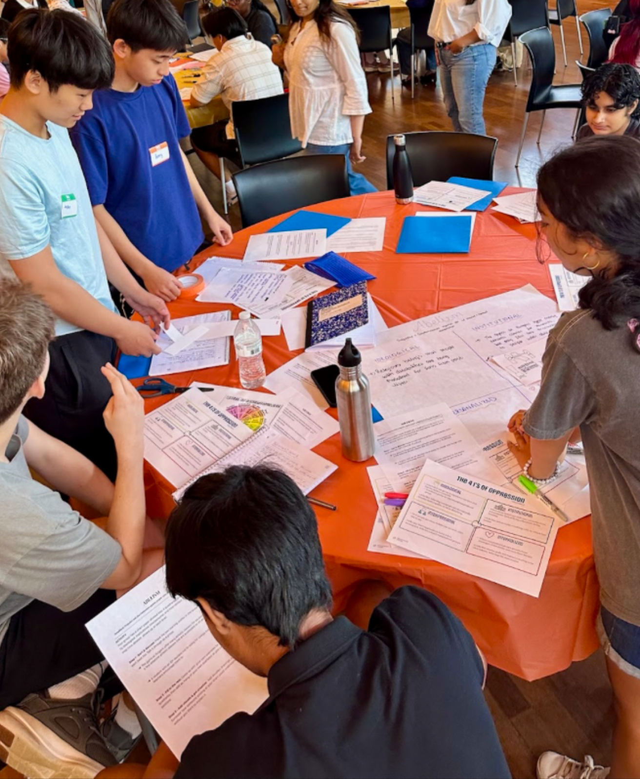 Students at a youth solidarity summit working with discussion materials created by Empowered Voices.