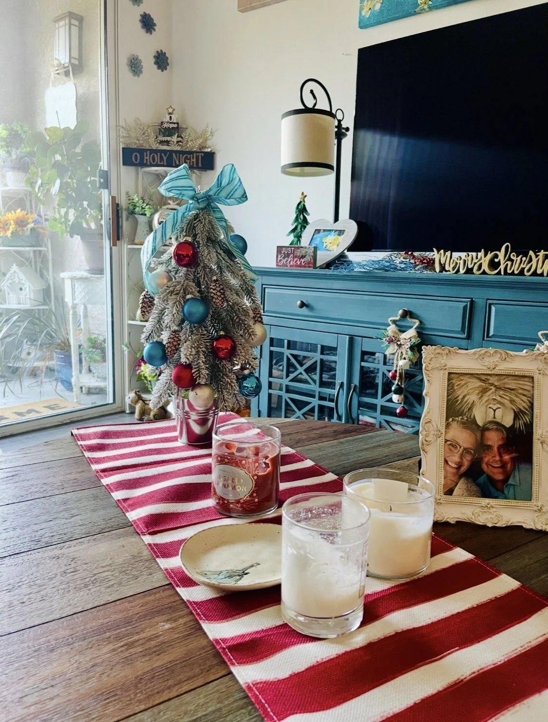 The Holiday Heart of the Home — Whimsical interior tabletop styling that sprinkles festive cheer straight into your everyday living spaces. This presentation coordinates a beautifully frosted miniature tree adorned with vibrant turquoise and crimson 