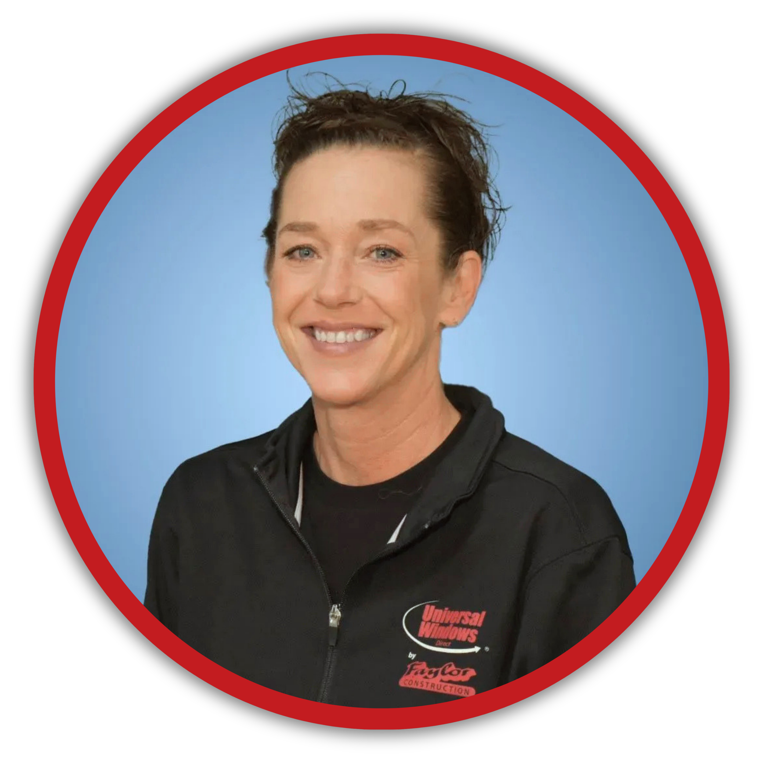 Close-up of a woman with short brown hair wearing a black jacket with a zipper. She is smiling and has blue eyes. The background is light blue and a red circle outlines the image. There is a logo on her jacket that says 'Universal Windows' and 'Faylor Construction'.
