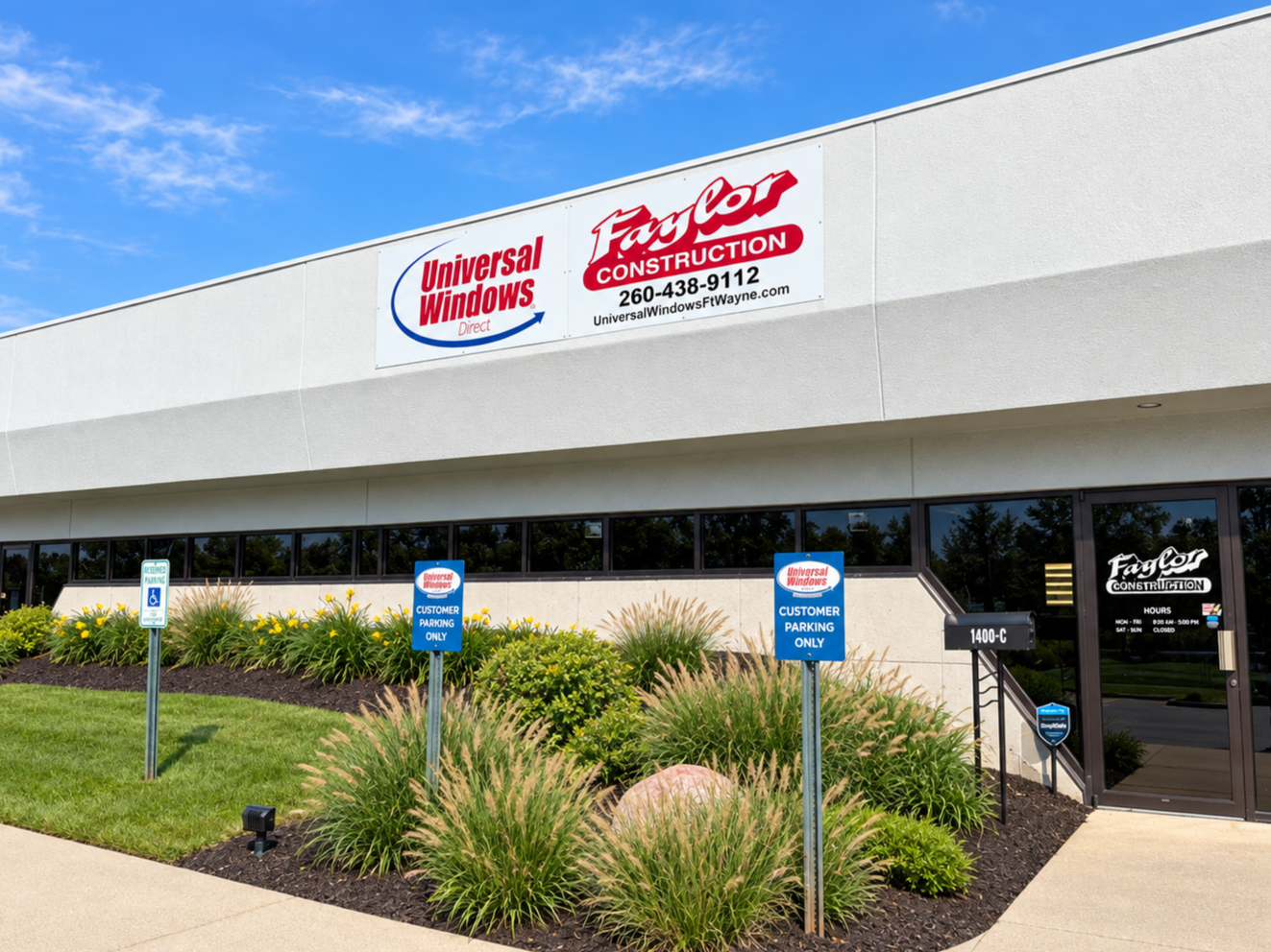 Exterior view of a commercial building with signage for Universal Windows and Faylor Construction, three customer parking signs, a landscaped area with bushes and rocks, and a glass entrance door.
