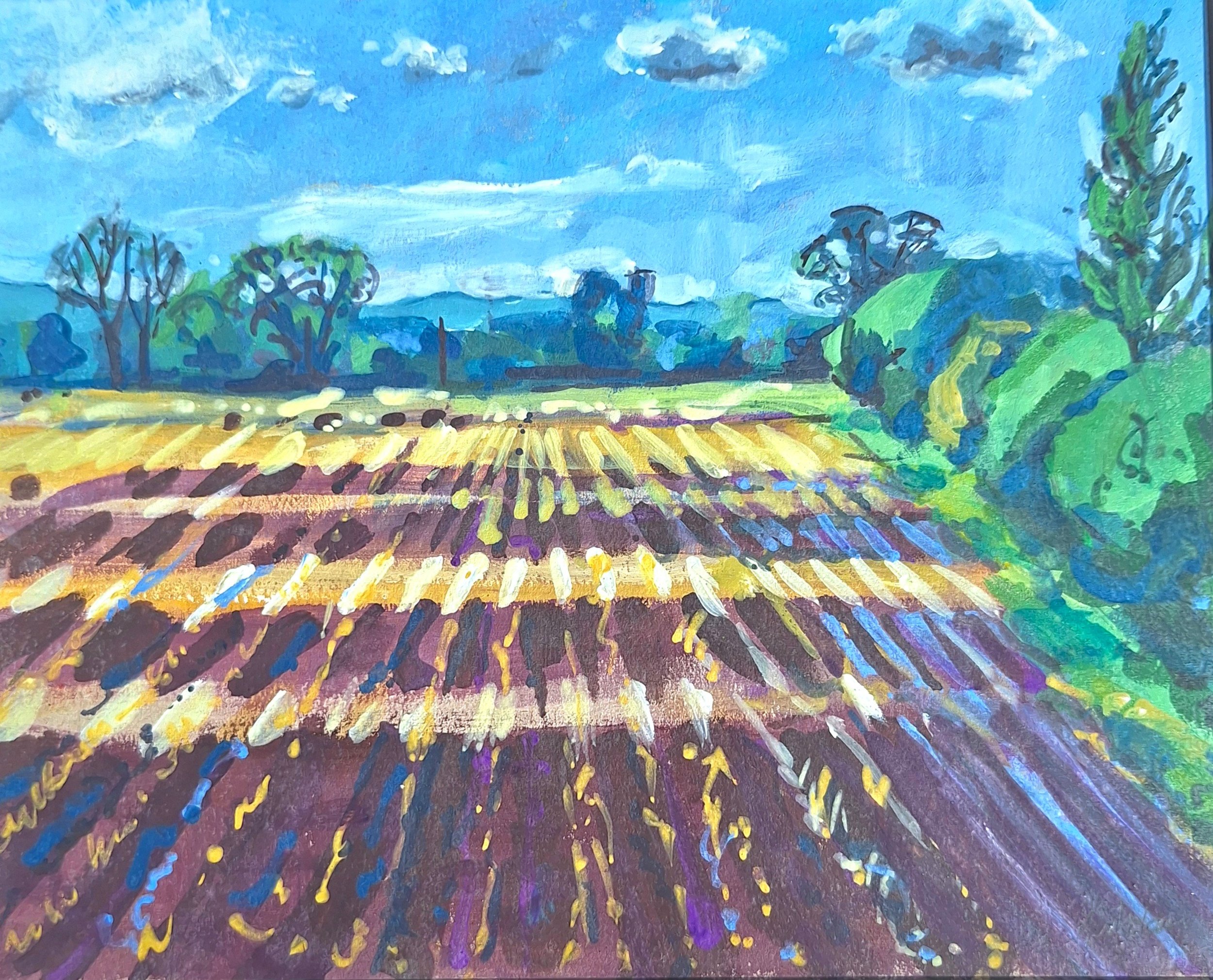 A colourful,  landscape painting  of a ploughed field with a blue sky, the shadows of clouds, green trees, and colourful, swirling brushstrokes.