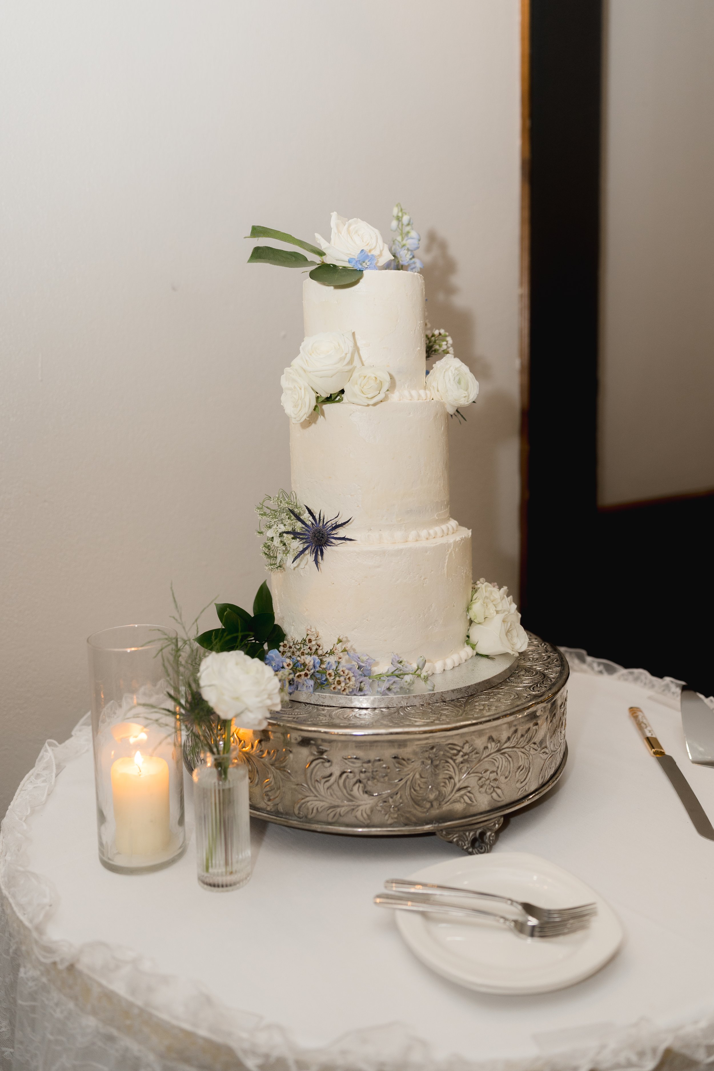 Three-tiered wedding cake at Wedding Reception at Best Western Gateway Grand captured by Florida Documentary Photographer Catherine Skelly