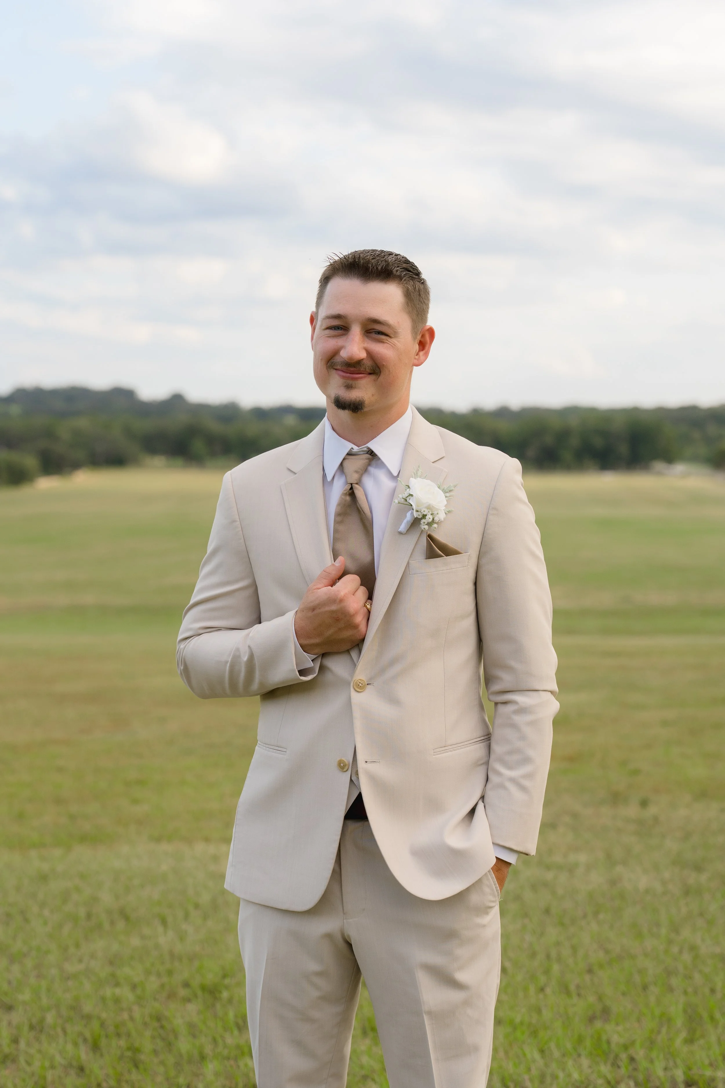 Tan groom suit captured at an Outdoor Wedding at Stonewood Events in Alachua, Florida captured by Florida Documentary Wedding Photographer Catherine Skelly