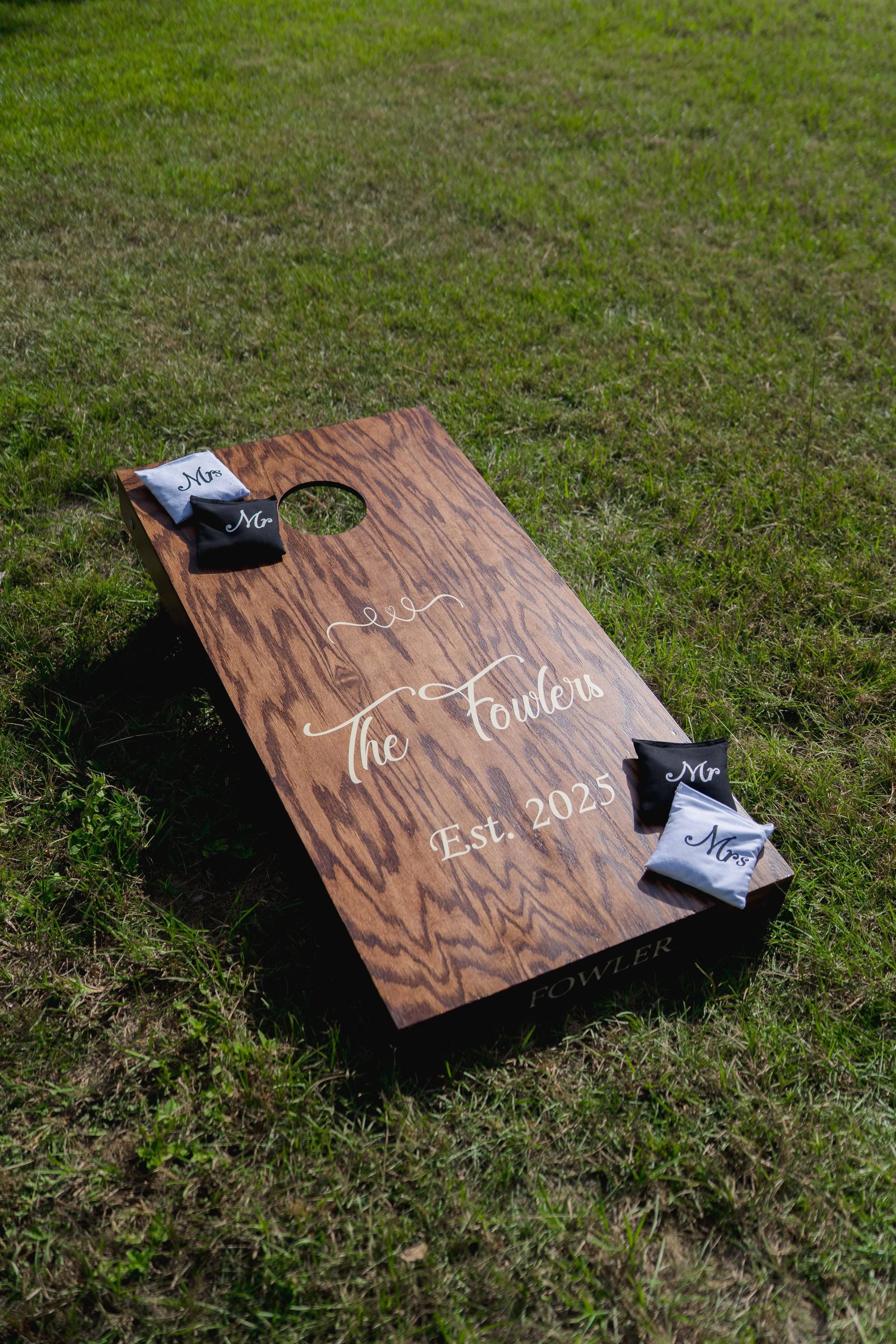 Customized Cornhole at Outdoor Wedding at Stonewood Events in Alachua, Florida captured by Florida Documentary Wedding Photographer Catherine Skelly