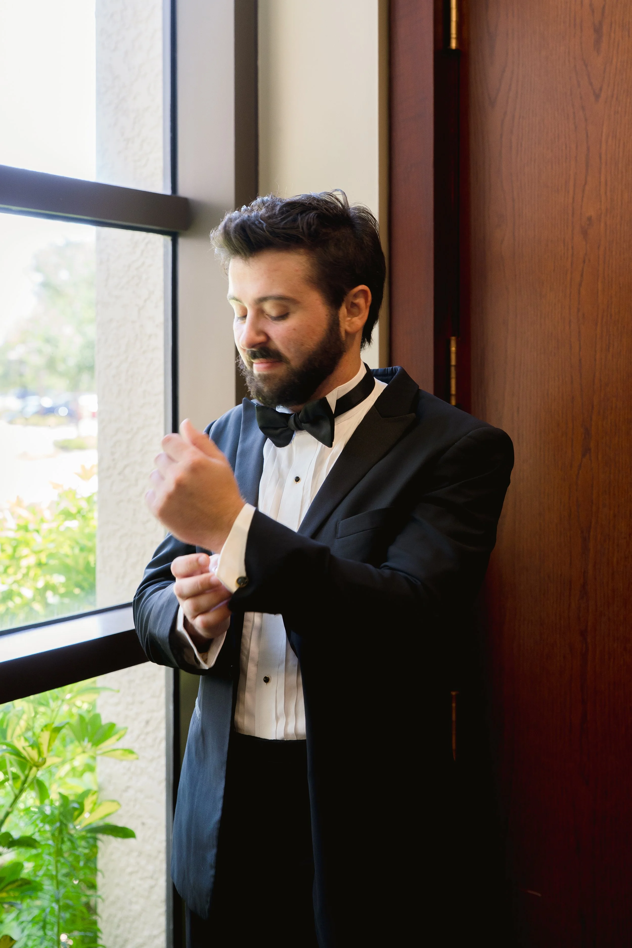 Groom getting ready photos in Ave Maria Catholic Church in Ave Maria, Florida by Florida Documentary Wedding Photographer Catherine Skelly
