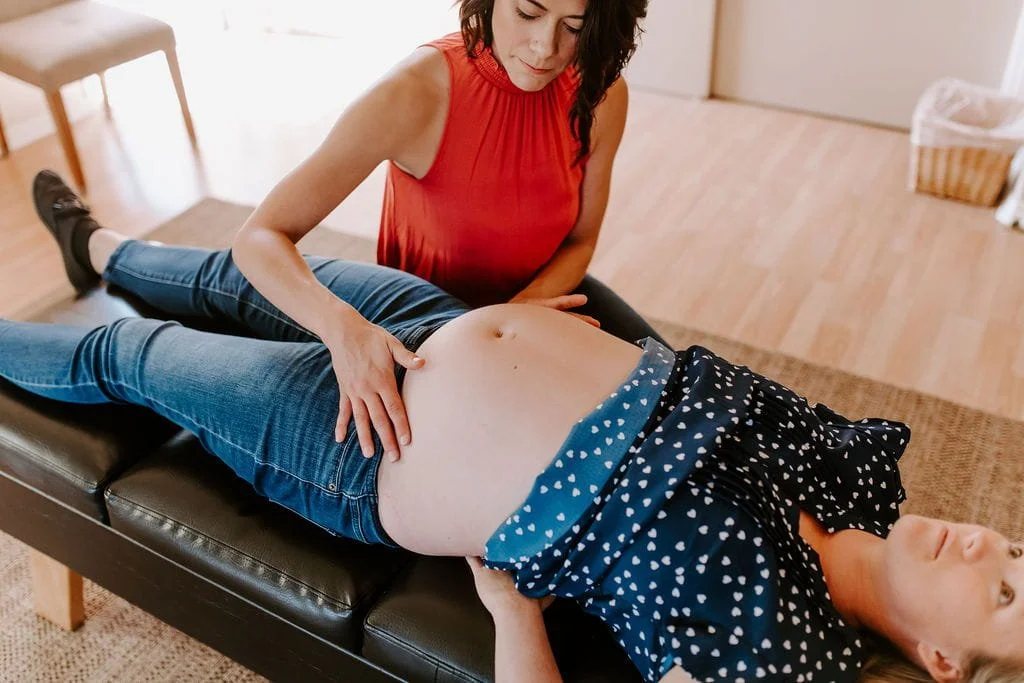 Woman receiving a chiropractic adjustment from a healthcare provider on a table in a clinic