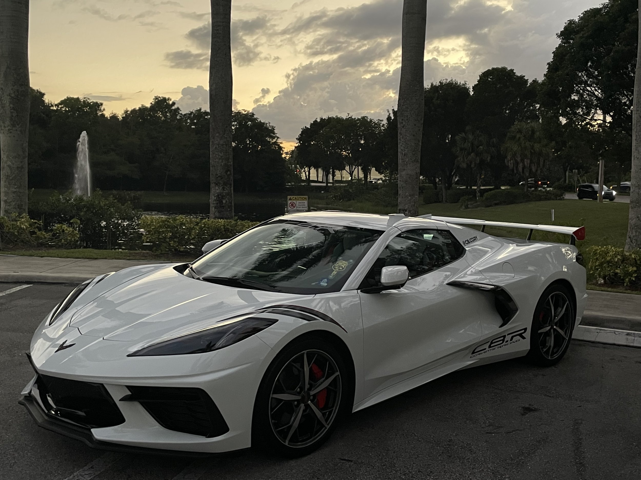 Professional wheel cleaning and ceramic protection details visible on a white Chevrolet Corvette C8 sports car in North Palm Beach.