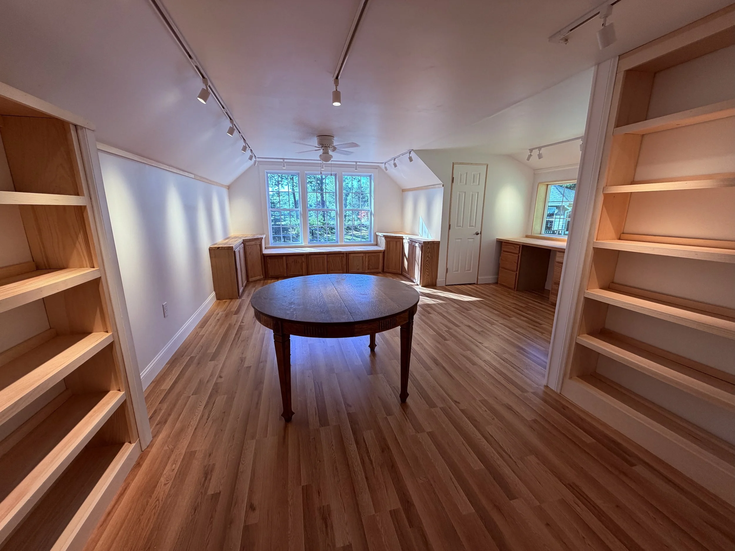 Interior of bright remodeled barn studio with lots of wood