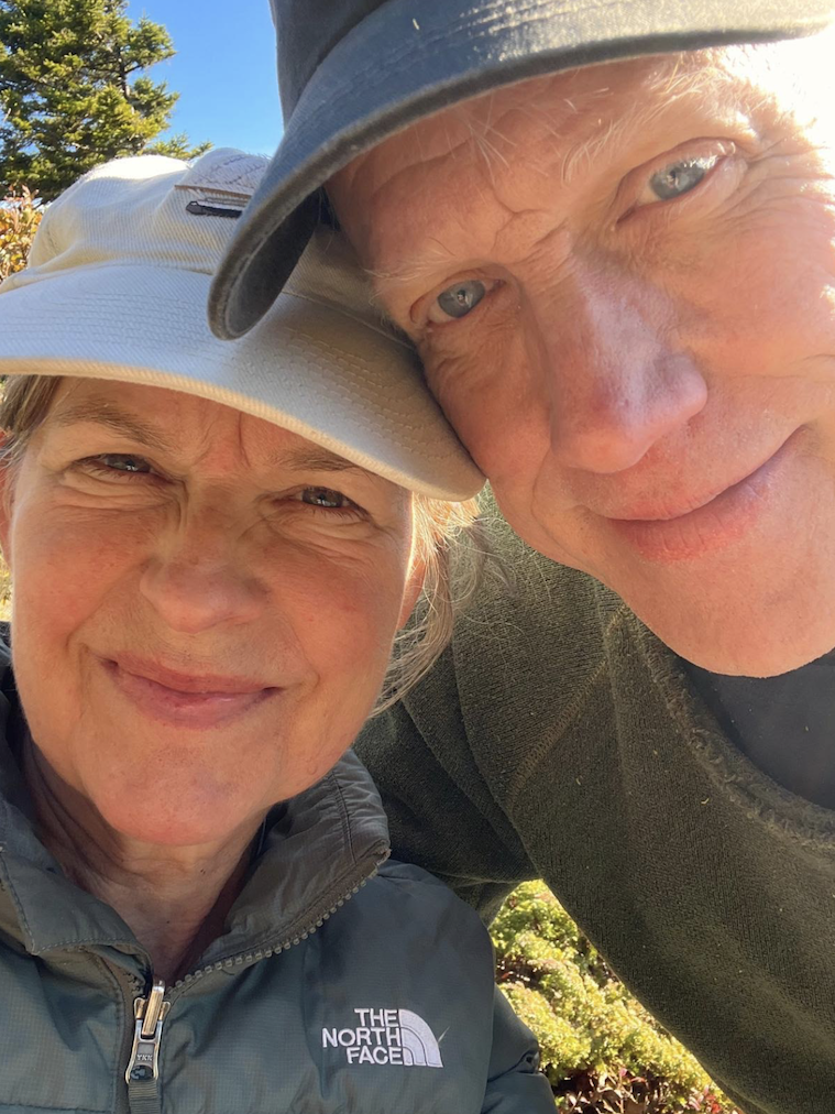 Charmaine Mary Johnson and her husband Tim with their heads together outdoors smiling