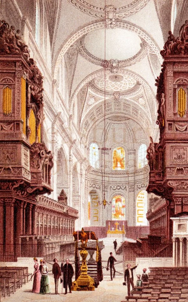 Interior of St Paul's Cathedral with high vaulted ceilings, ornate woodwork, stained glass windows, and a central altar with a statue and candles. Several people are standing and sitting, some engaged in conversation.